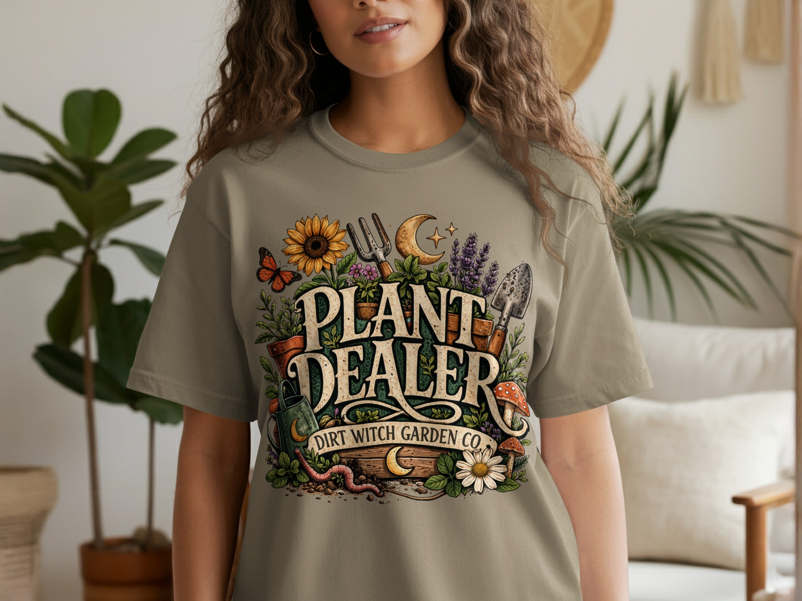 T-shirt with "PLANT DEALER DIRT WITCH GARDEN CO." text and floral design.
