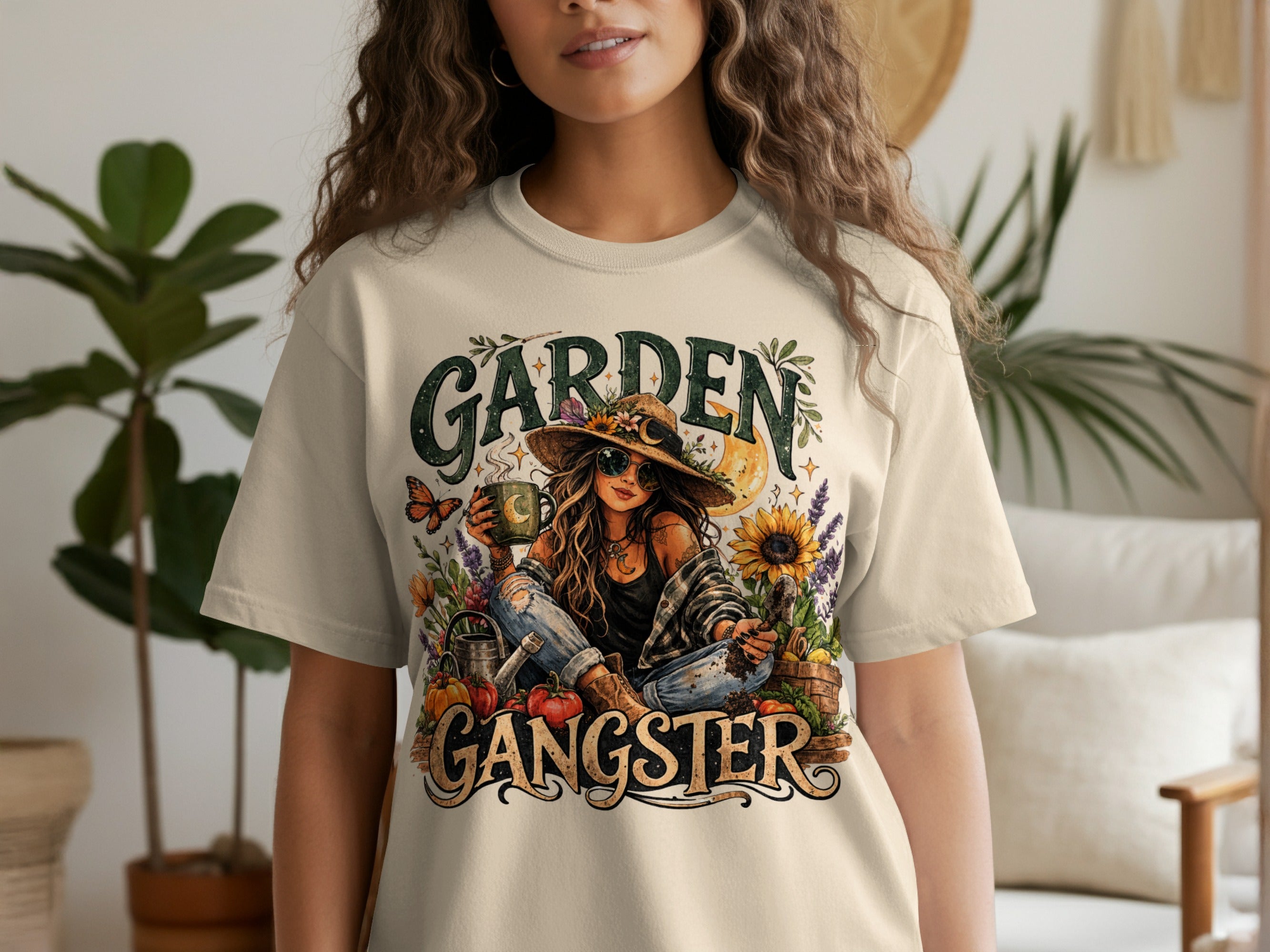 Garden Gangster graphic on a cream t-shirt featuring a woman with gardening tools and plants.