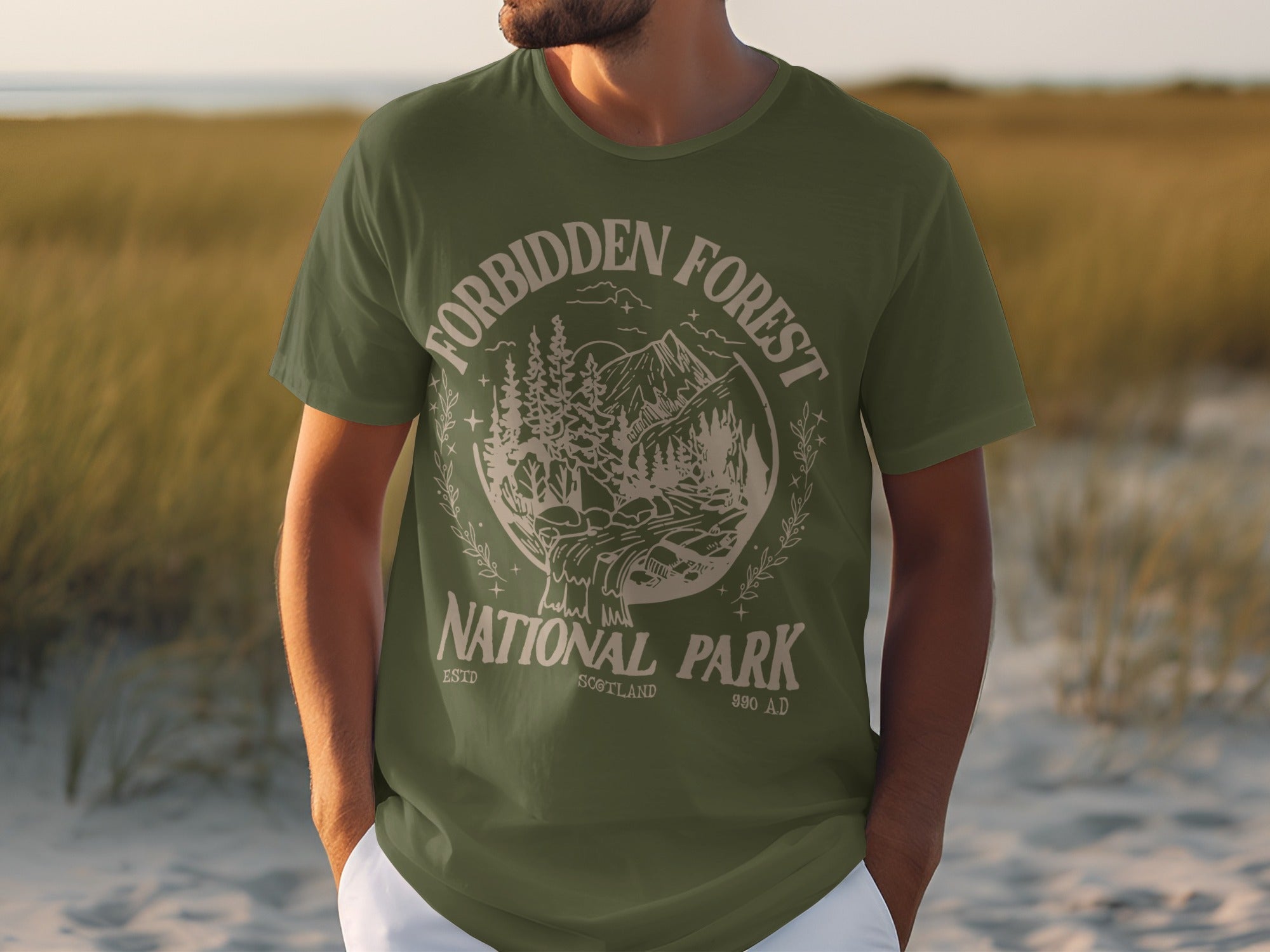 Green t-shirt with "Forbidden Forest National Park Scotland 990 AD" graphic.