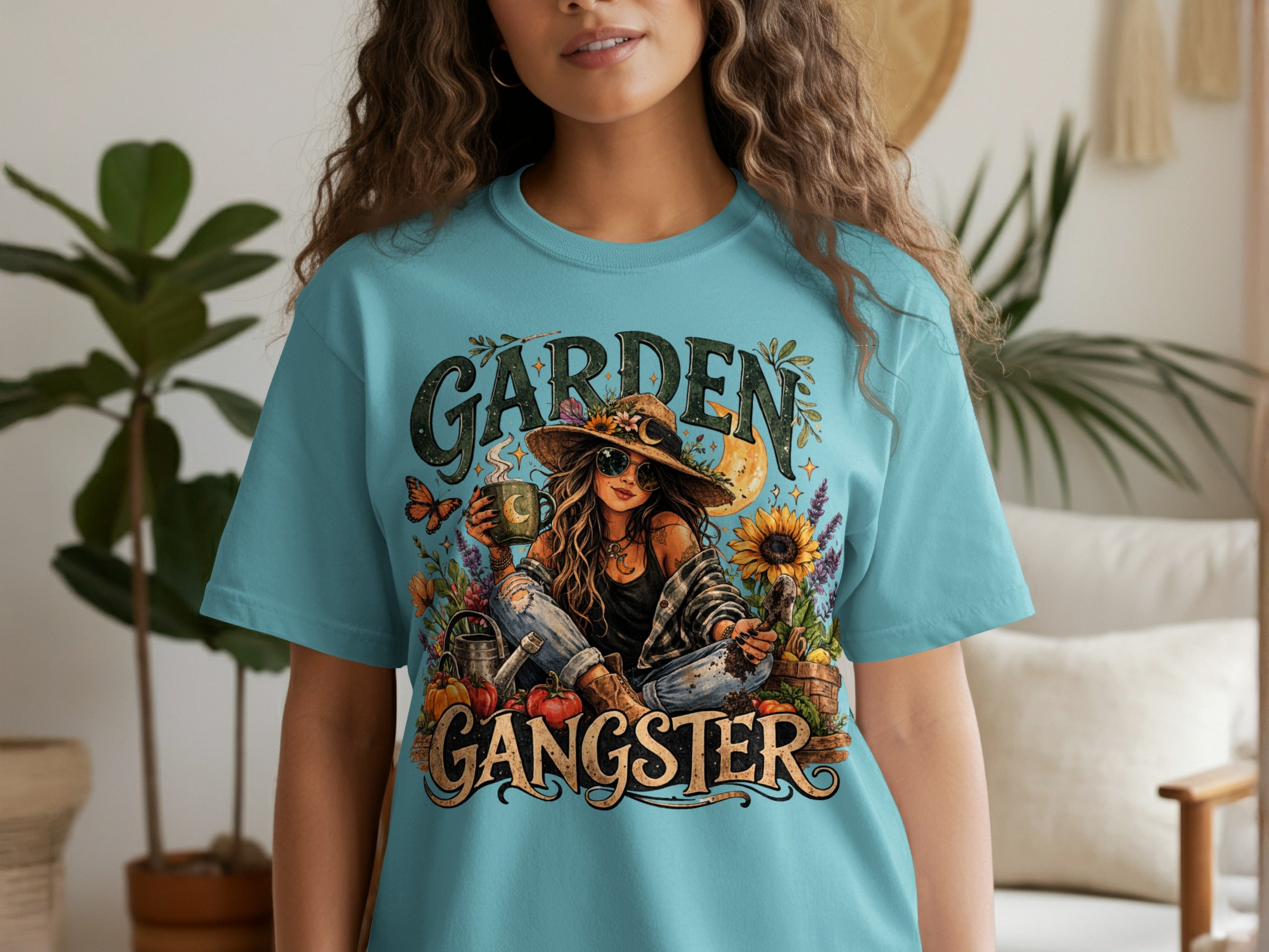 Graphic tee with "Garden Gangster" text and illustration of a woman gardening with a moon and sun.
