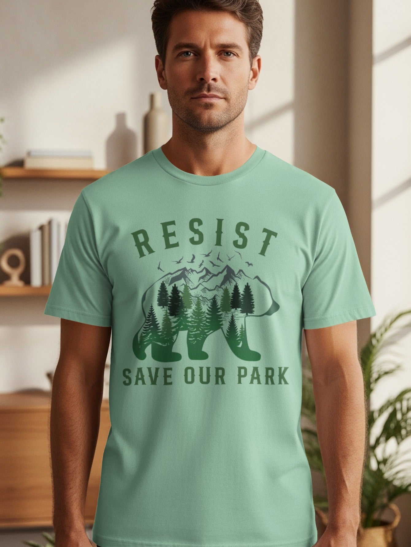 Men's green t-shirt with "RESIST SAVE OUR PARK" text and bear silhouette graphic.