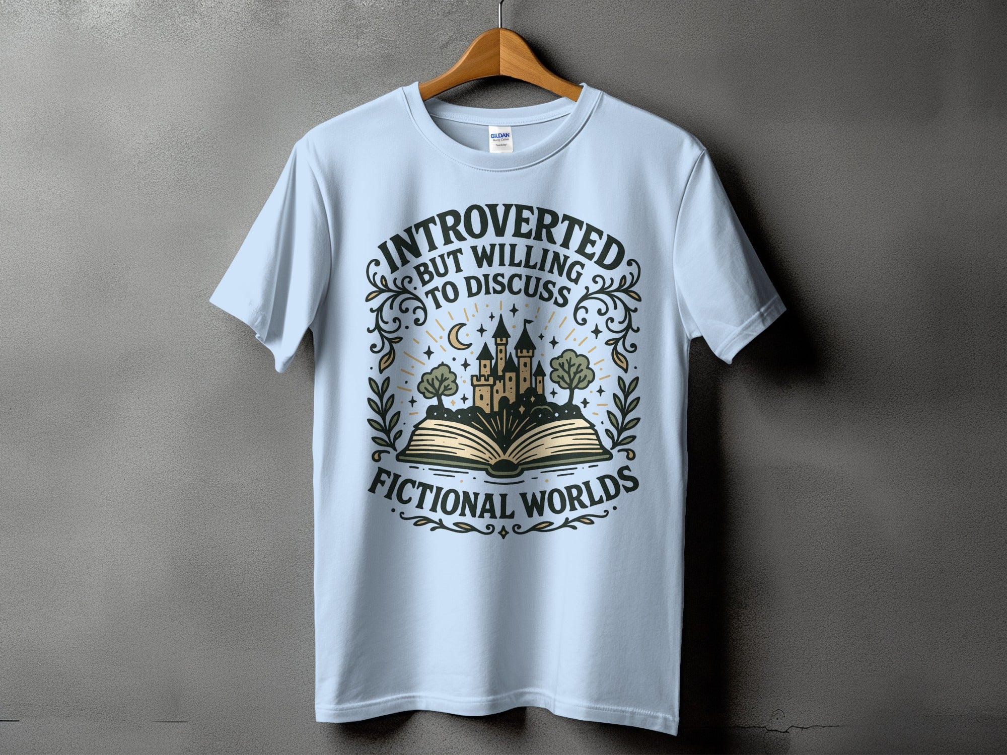 Light blue t-shirt displaying text "INTROVERTED BUT WILLING TO DISCUSS FICTIONAL WORLDS".