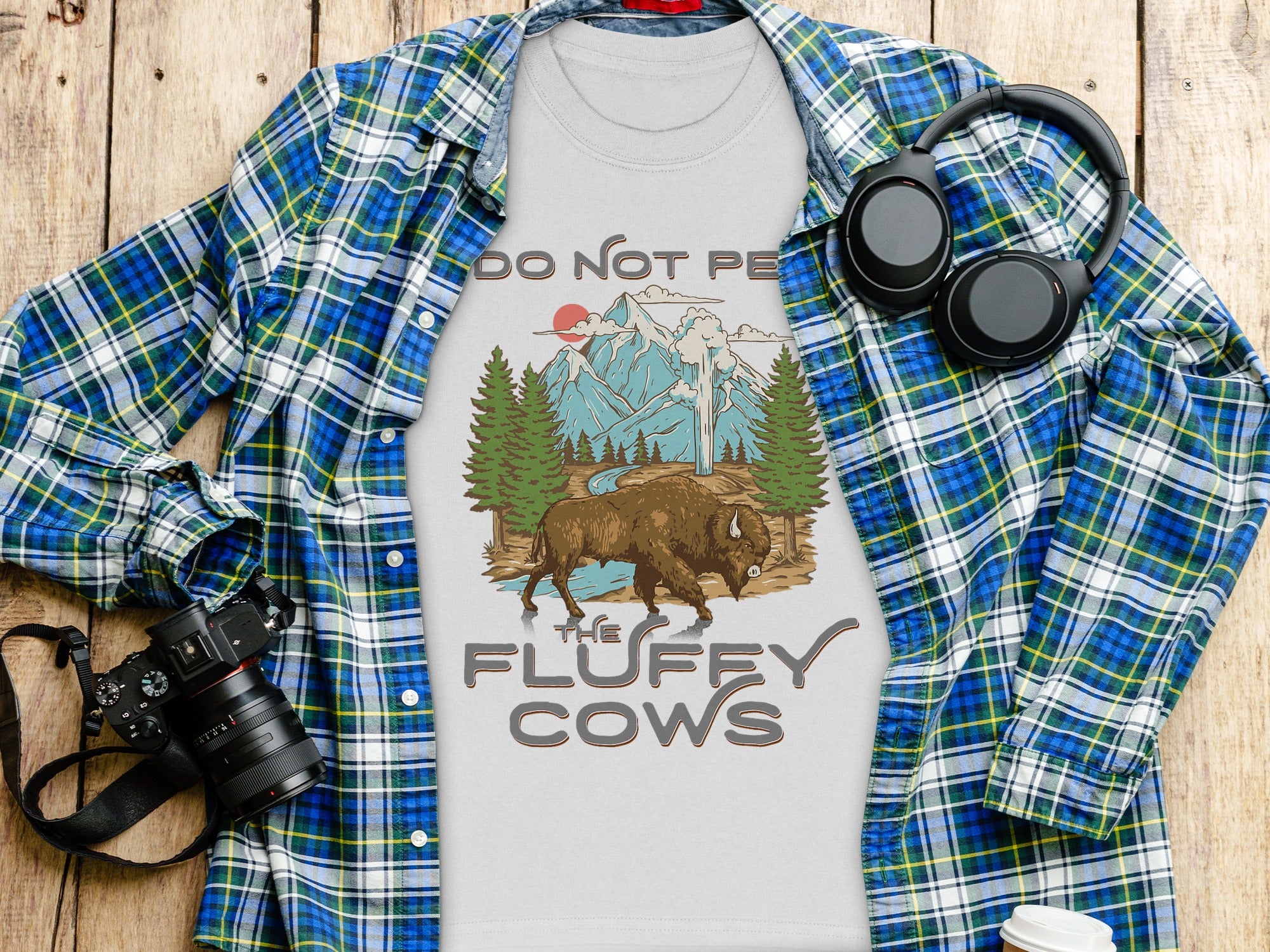 White t-shirt with text "DO NOT PE" and bison in mountain landscape, "THE FLUFFY COWS"
