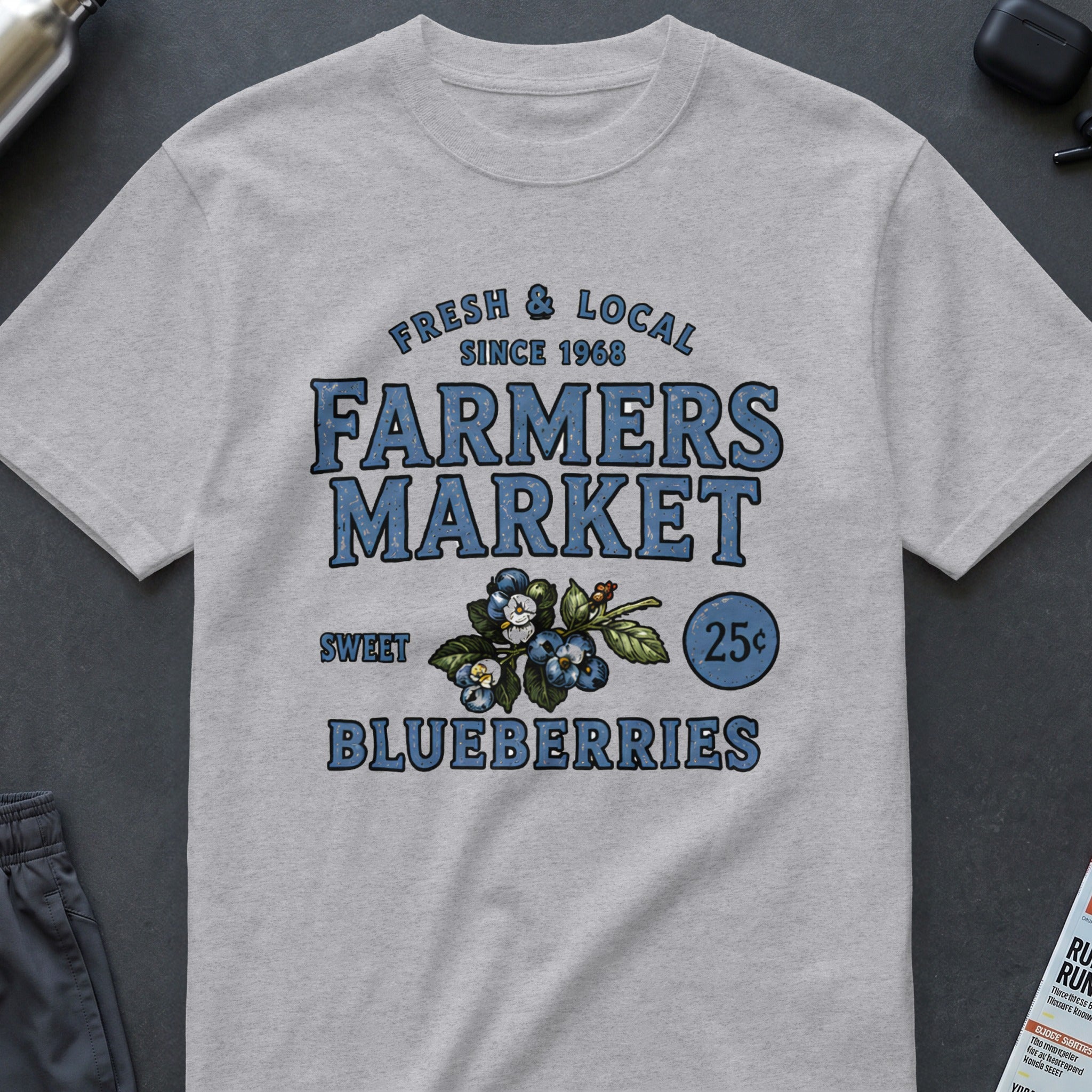 Grey t-shirt with "Farmers Market Sweet Blueberries Since 1968" text and blueberry graphic.