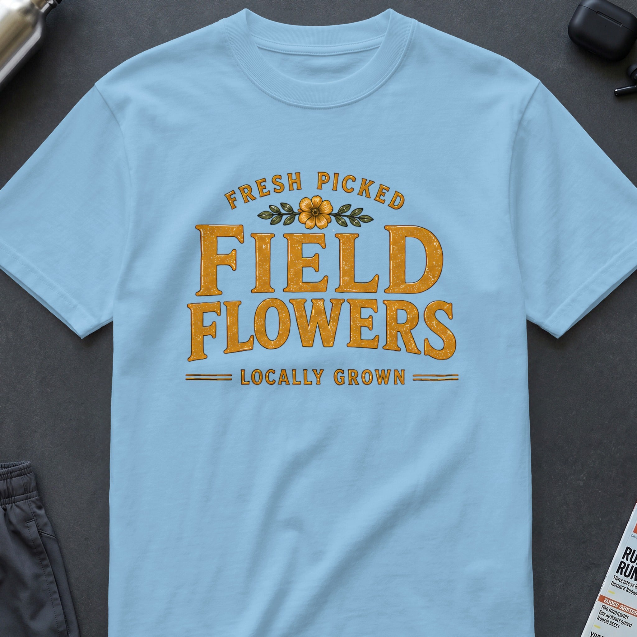 Light blue t-shirt with "Fresh Picked Field Flowers Locally Grown" text.