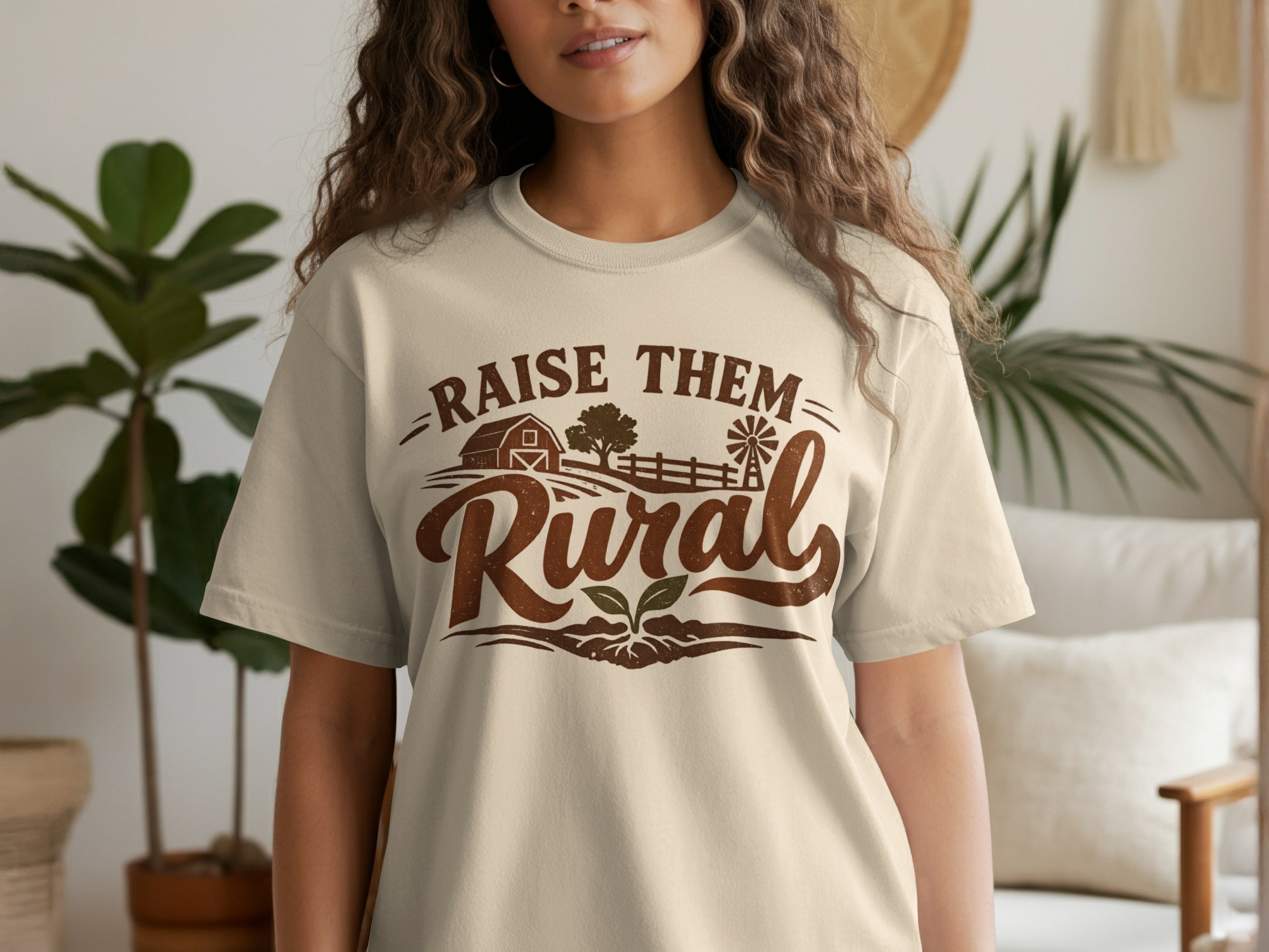 Cream t-shirt with "Raise Them Rural" text and farm graphic.
