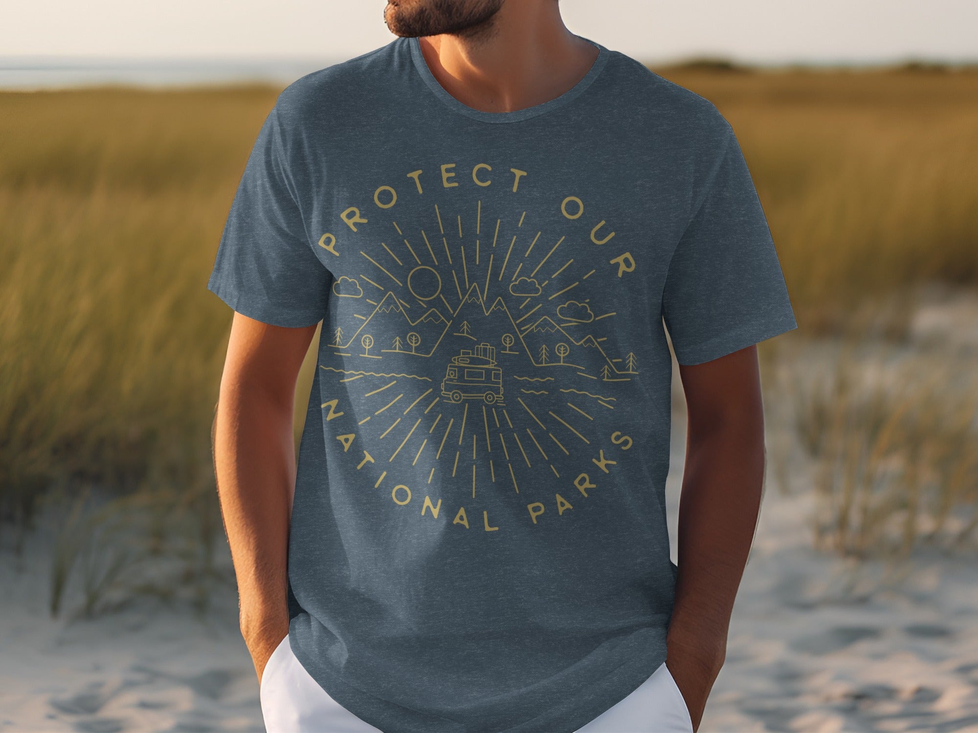 Dark blue t-shirt with a gold circular graphic of mountains, trees, clouds, and a camper van.