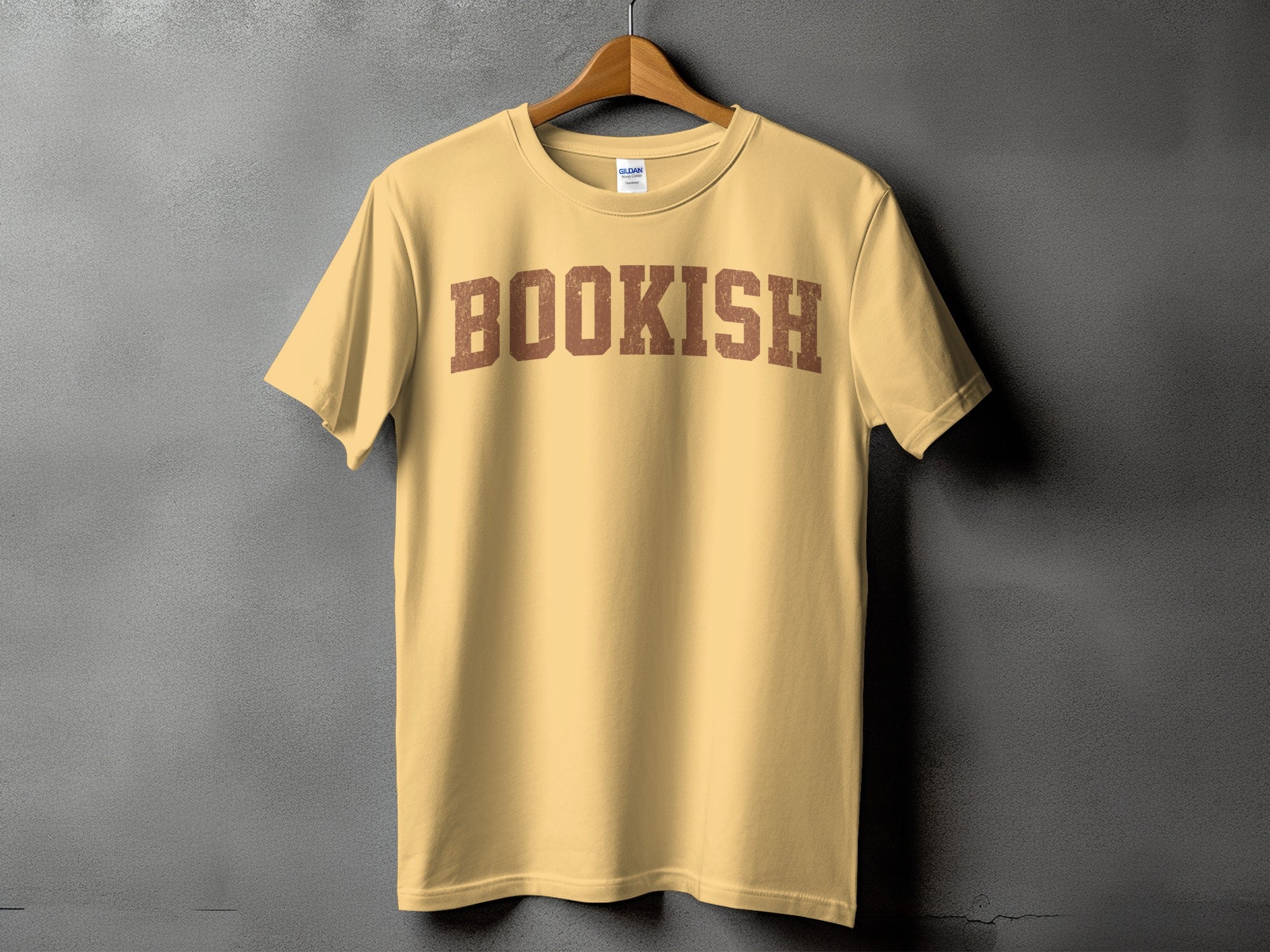 Light yellow t-shirt with the word "BOOKISH" in distressed brown collegiate lettering.