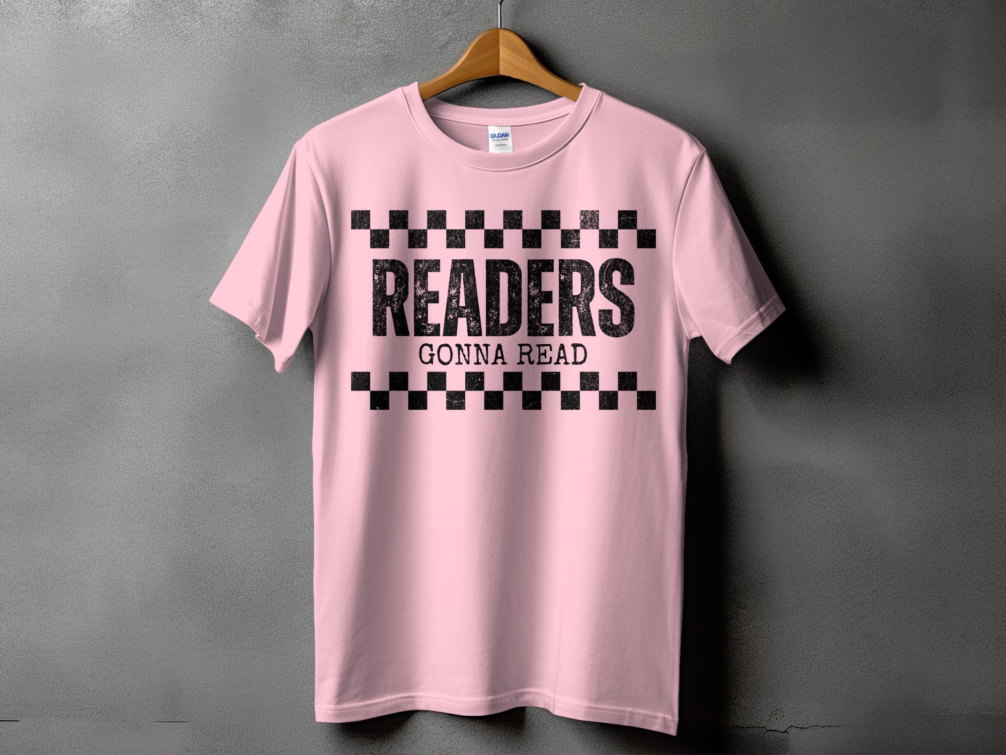 Pink t-shirt with black text "READERS GONNA READ" and checkerboard pattern.