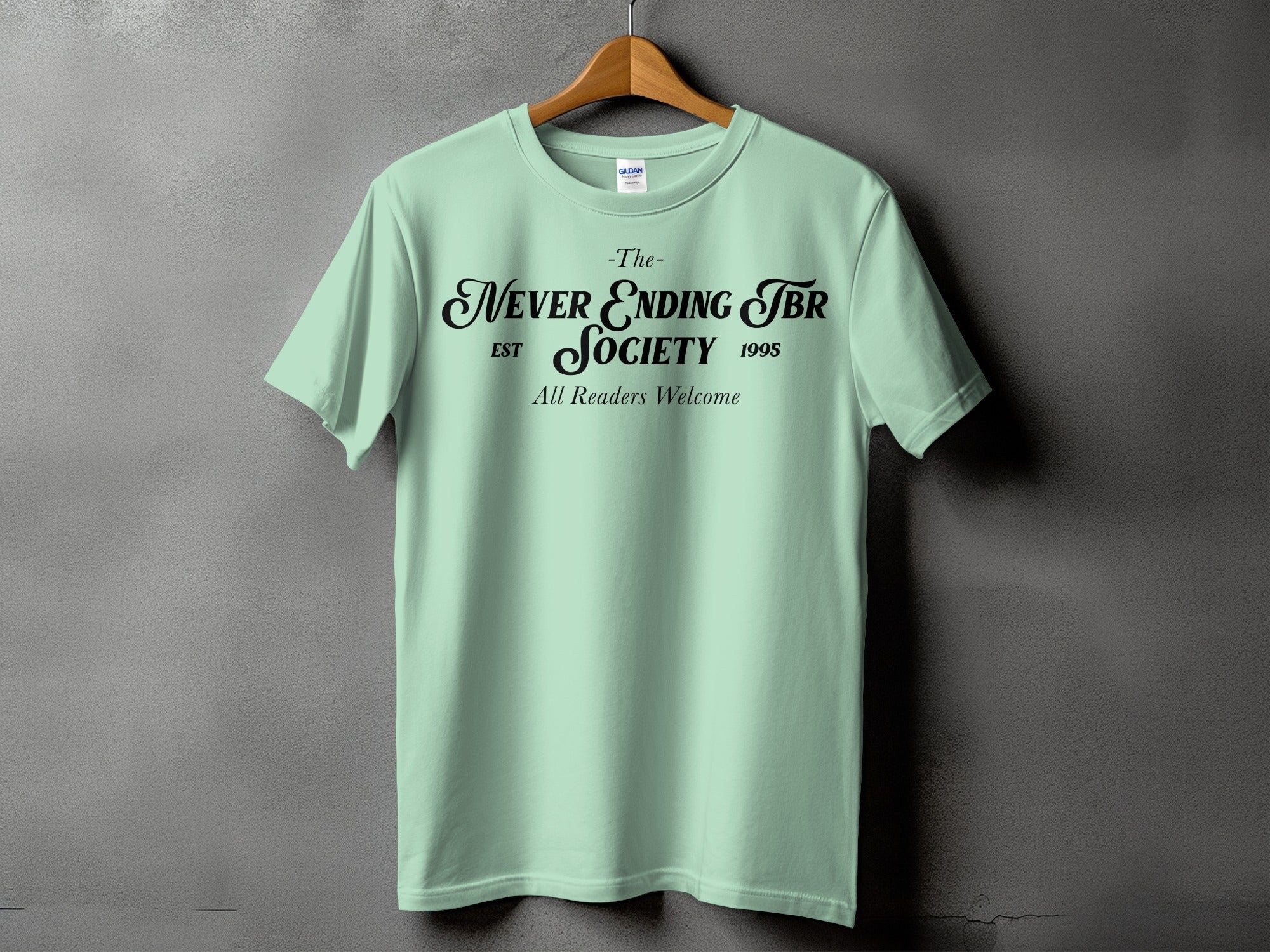 Mint green t-shirt with black text "The- Never Ending JBR Society Est 1995 All Readers Welcome".