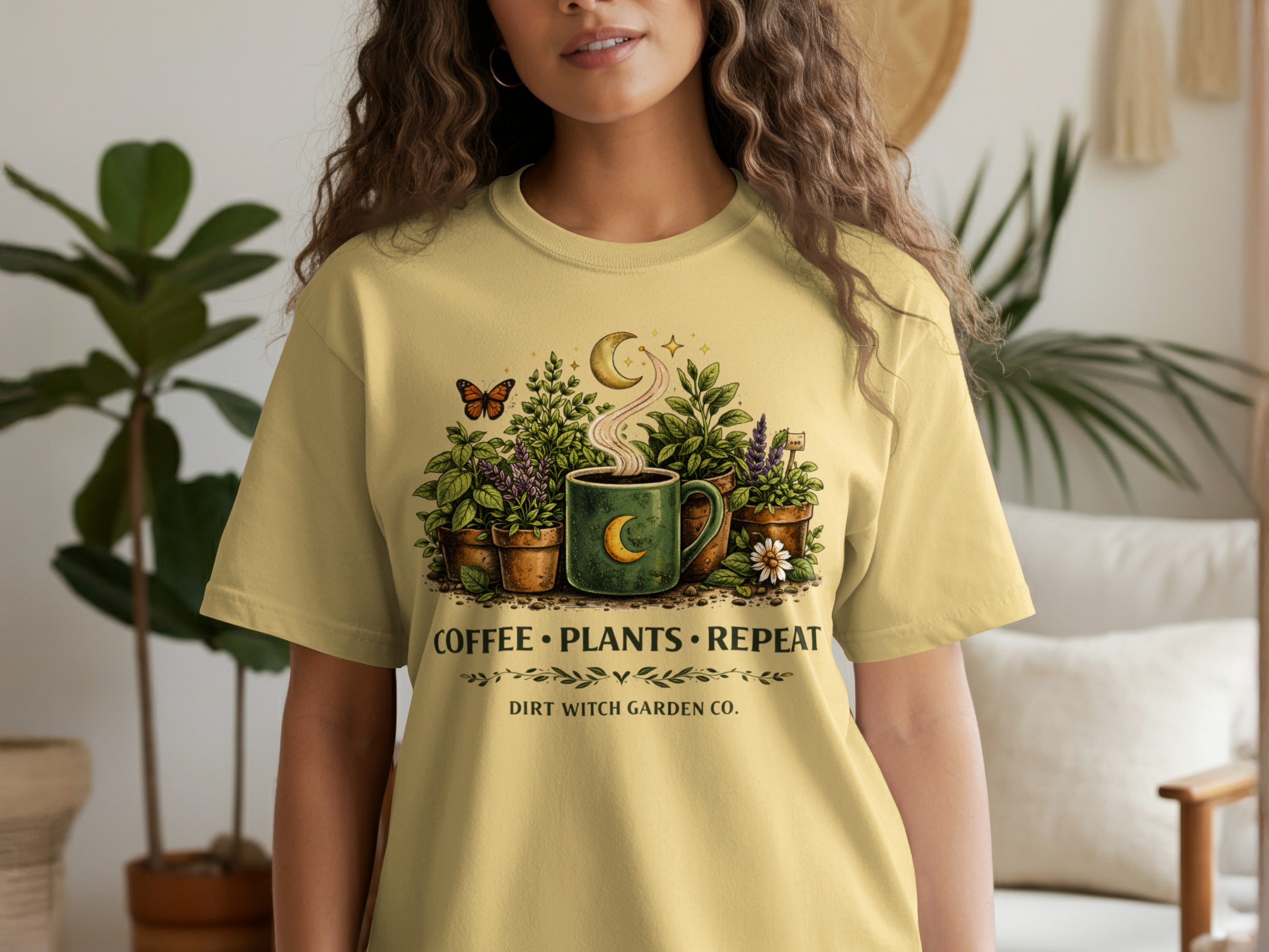 Yellow t-shirt with "Coffee⚫Plants⚫Repeat" and "Dirt Witch Garden Co." text and artwork.