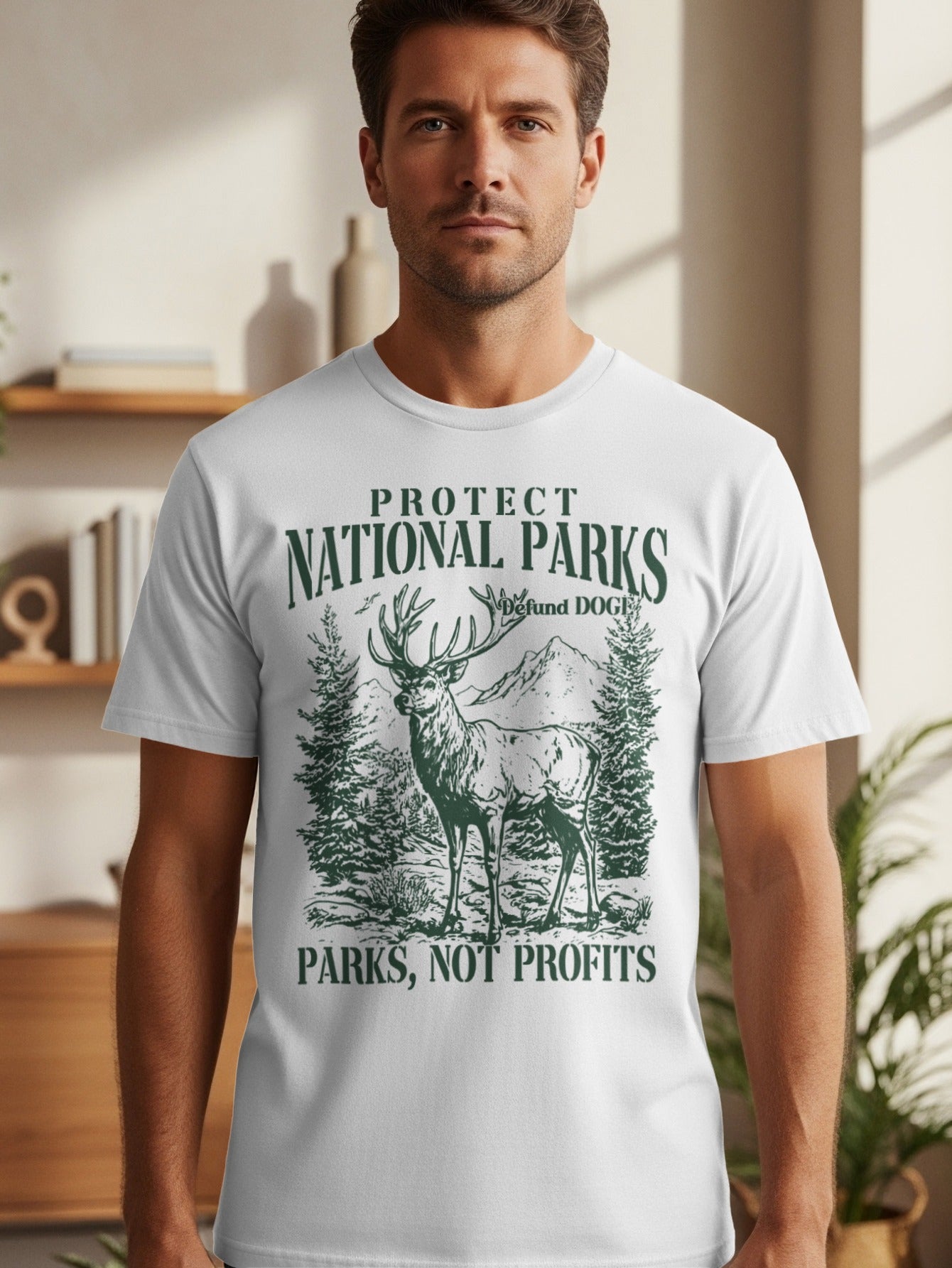 White t-shirt with green illustration of deer, trees, and mountains. Text reads "Protect National Parks" and "Parks, Not Profits."