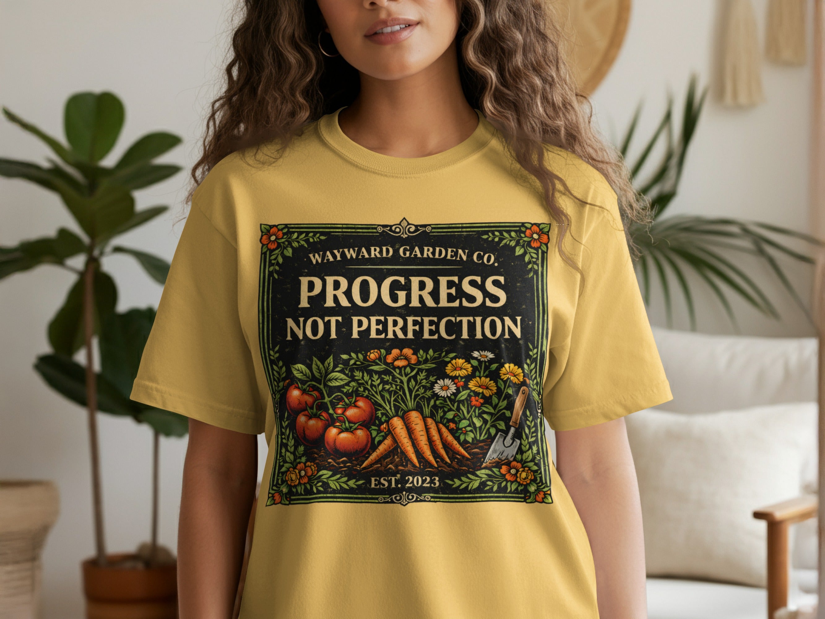 Yellow t-shirt with "Wayward Garden Co. Progress Not Perfection" and garden imagery.