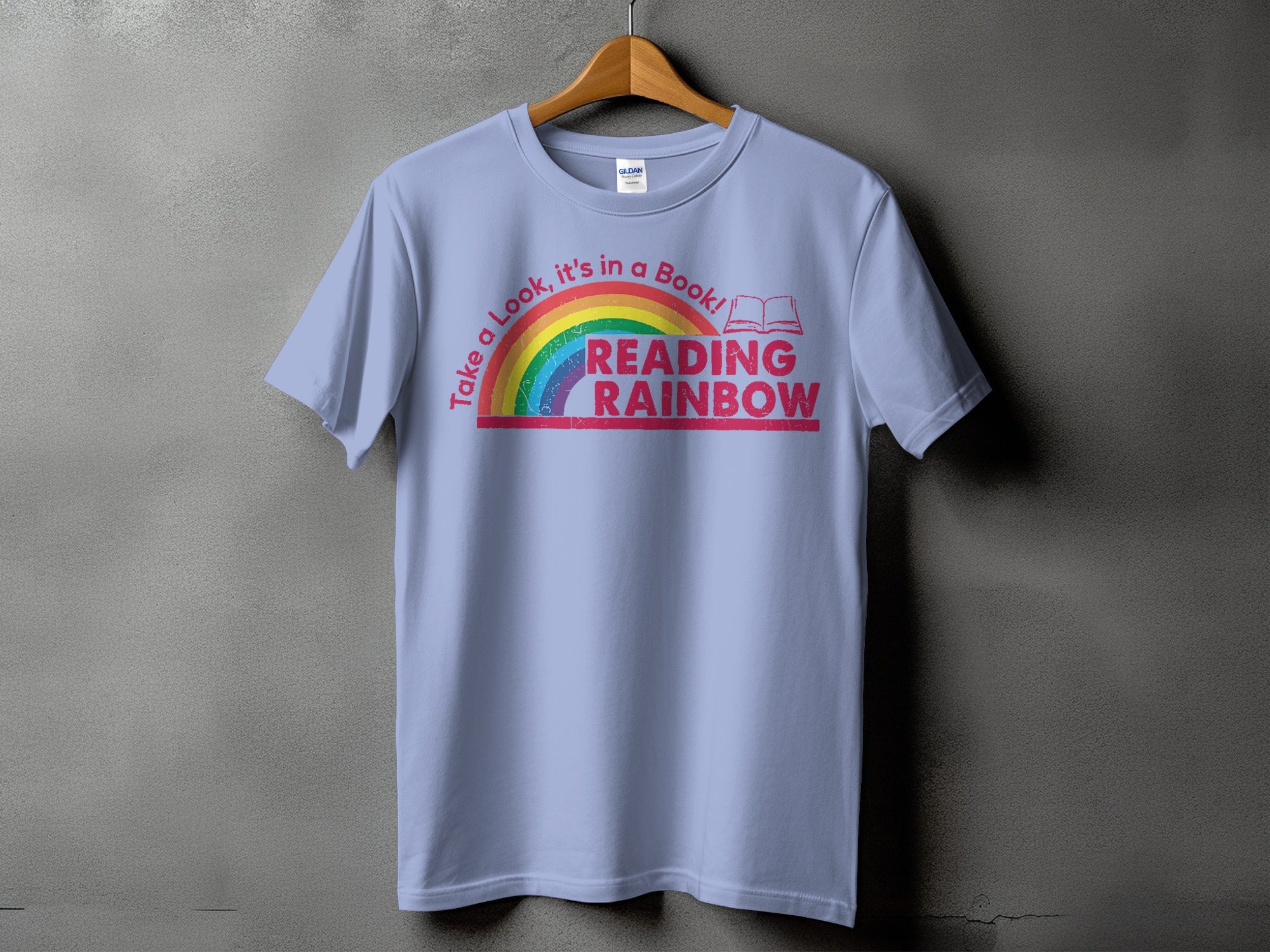 Light purple t-shirt with rainbow and "Reading Rainbow" text.