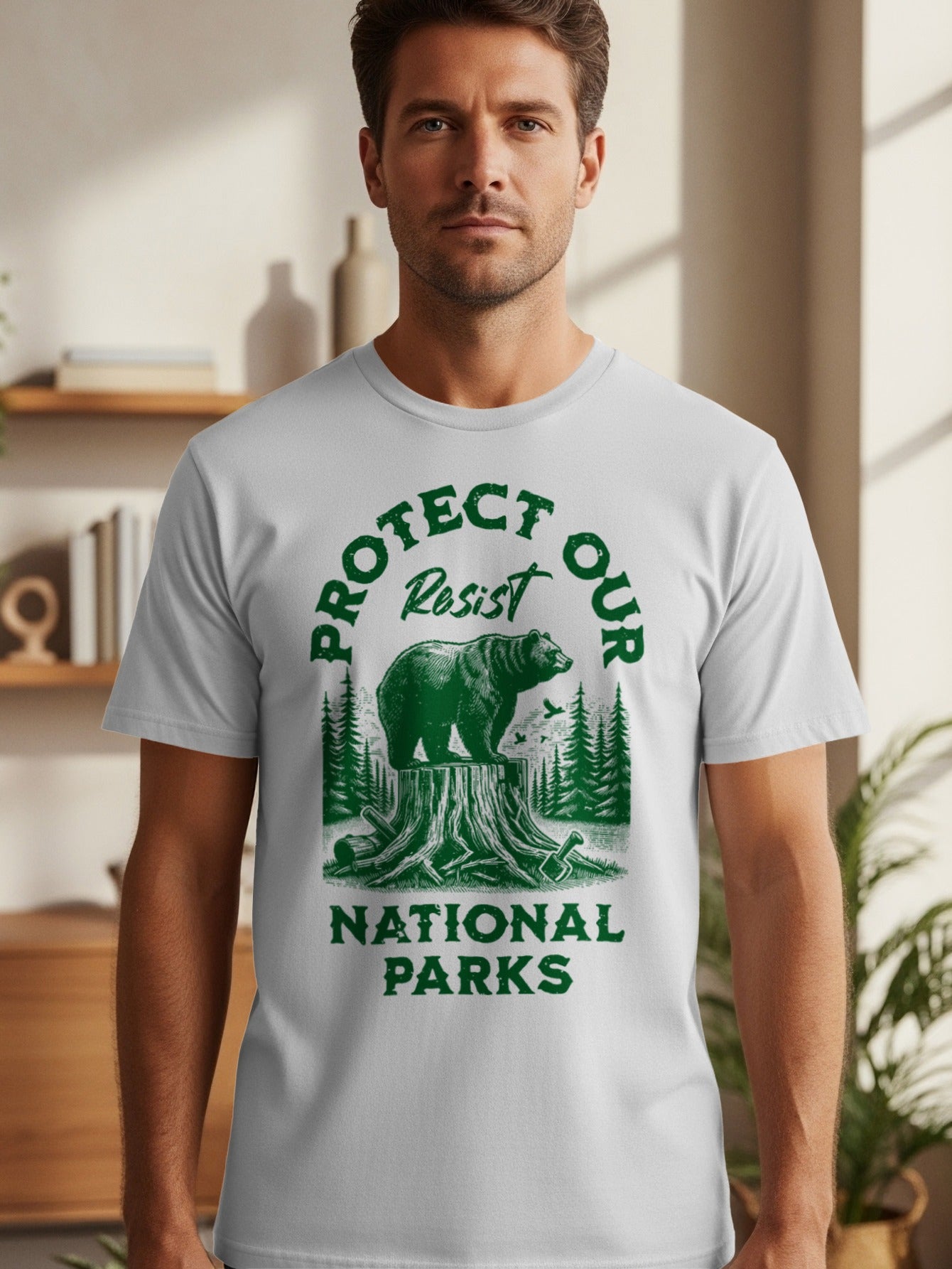 White t-shirt graphic with green text and bear on tree stump.