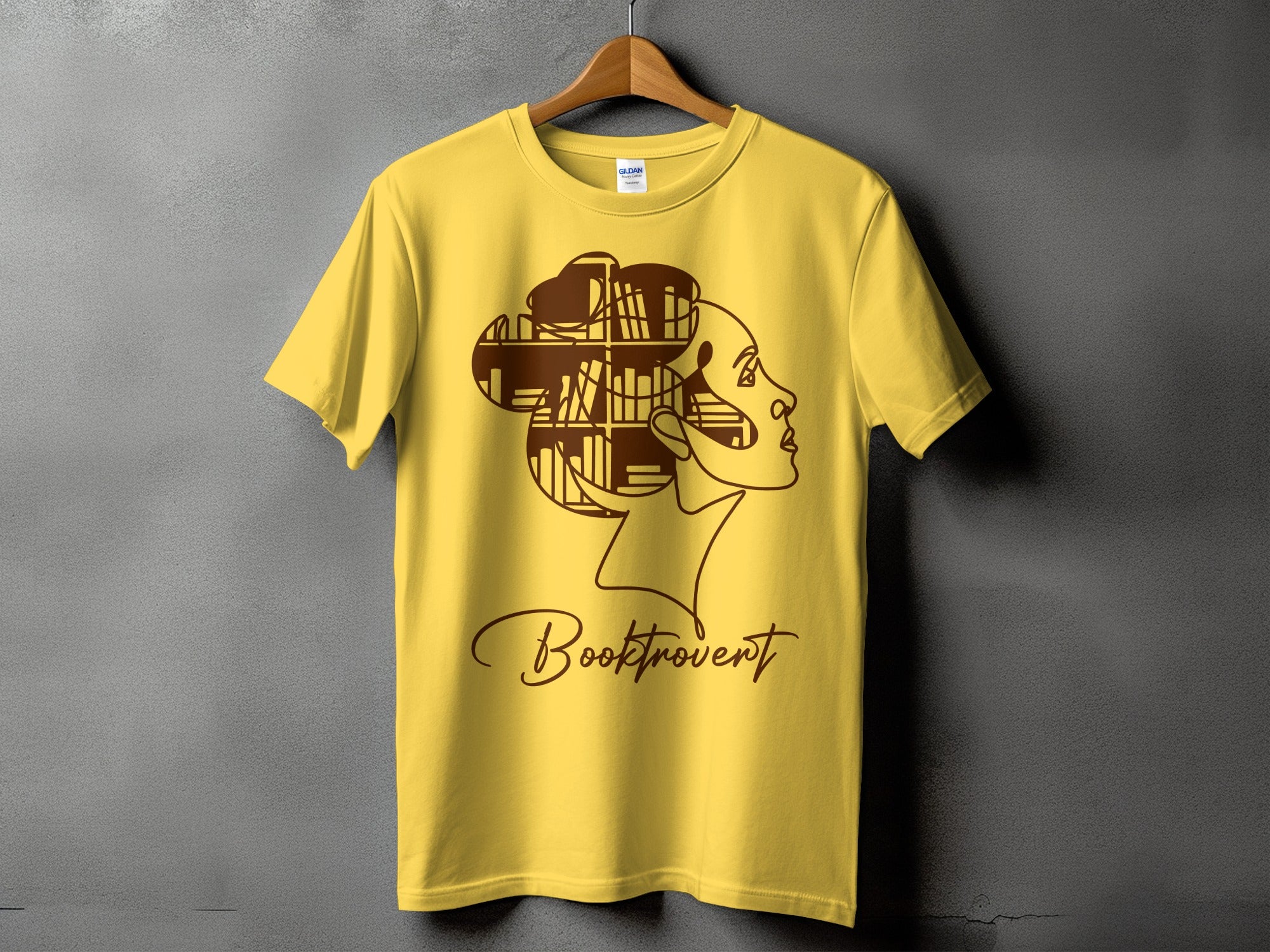 Yellow t-shirt with brown outline of a profile and "Booktrovert" text.