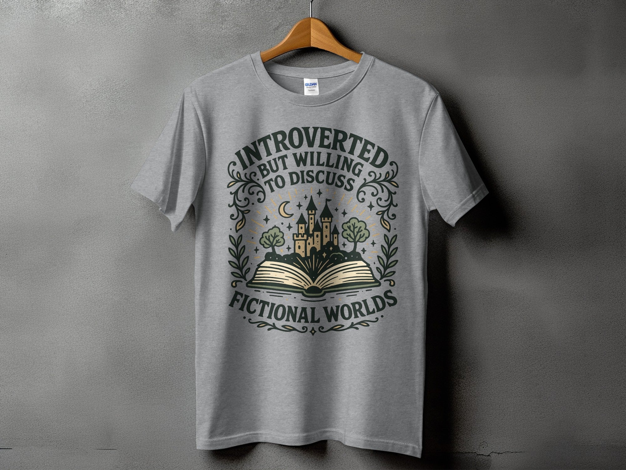 Grey t-shirt with text "Introverted but willing to discuss fictional worlds" and fantasy castle graphic.