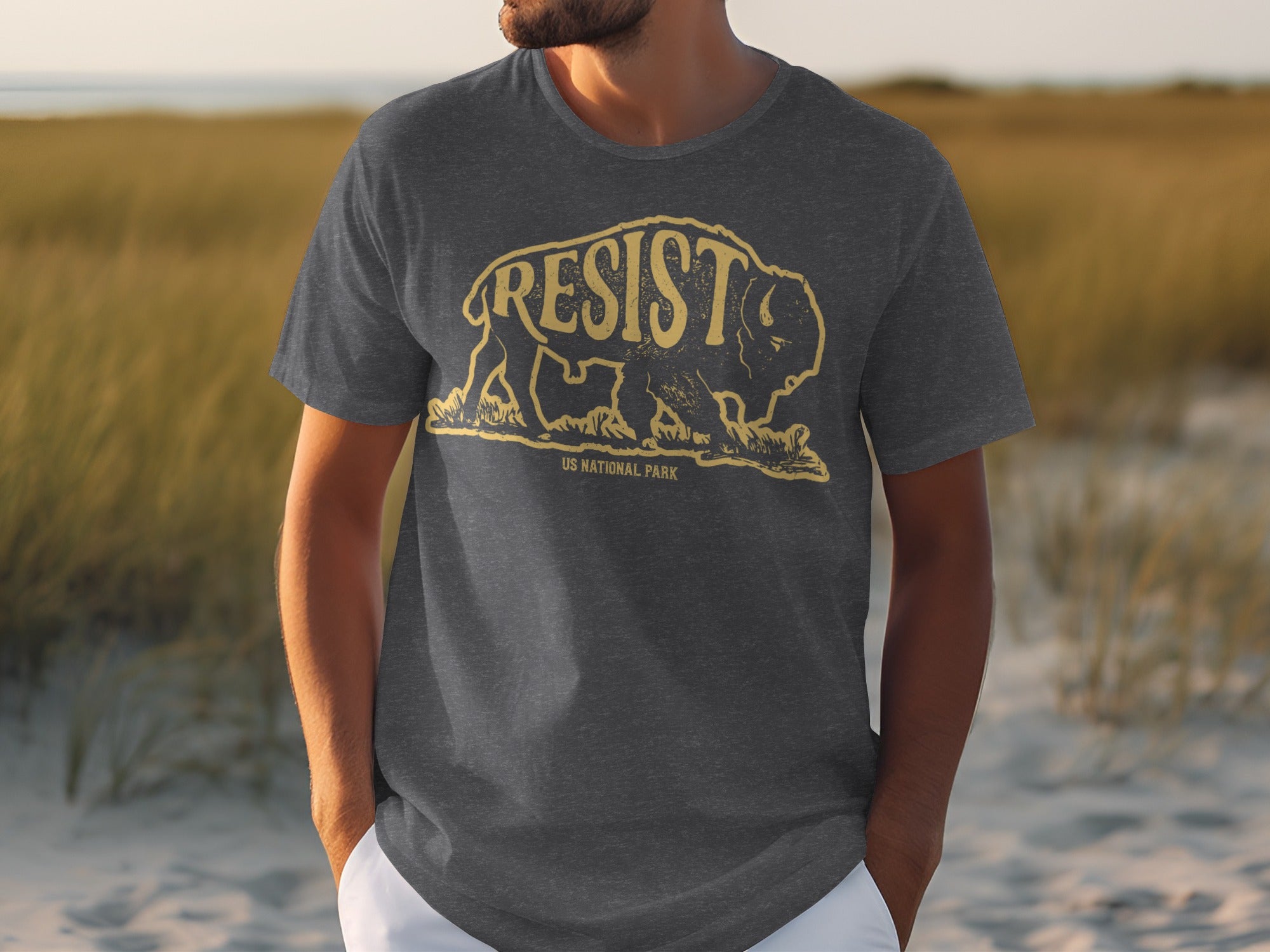 Dark grey t-shirt with yellow bison graphic and "RESIST US NATIONAL PARK" text.