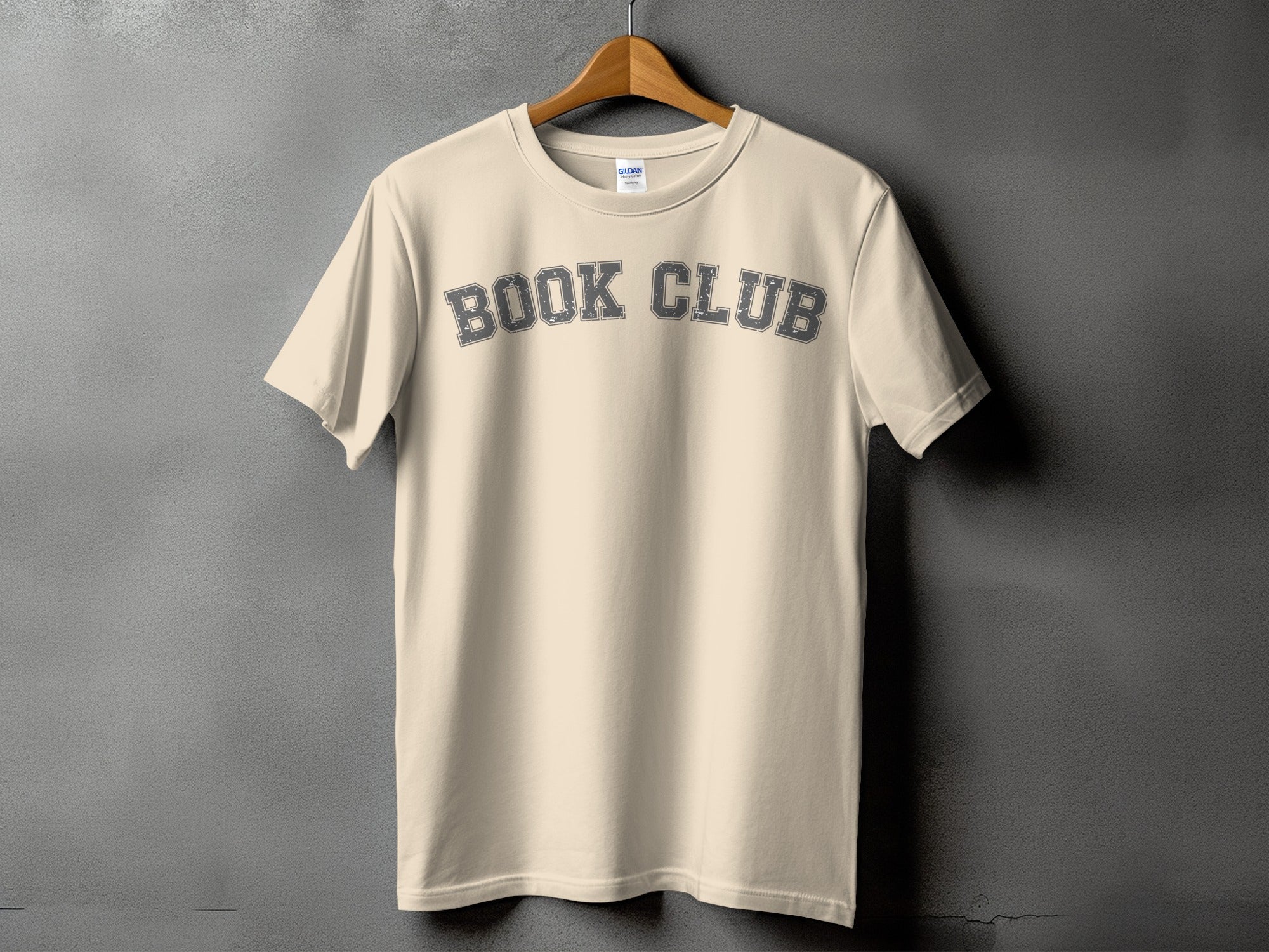 Cream t-shirt with "BOOK CLUB" arched graphic in distressed gray text.