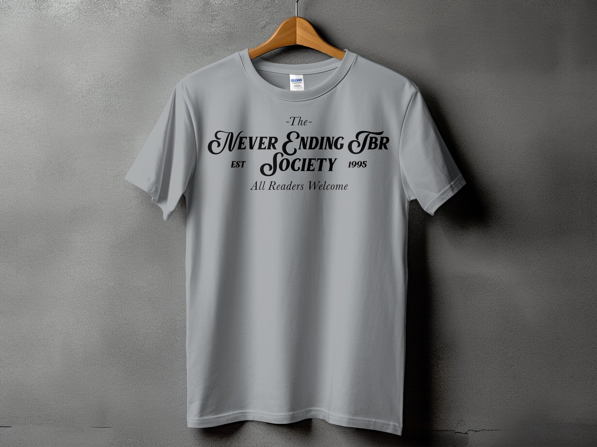 Grey t-shirt with "The Never Ending TBR Society Est 1995 All Readers Welcome" in black text.