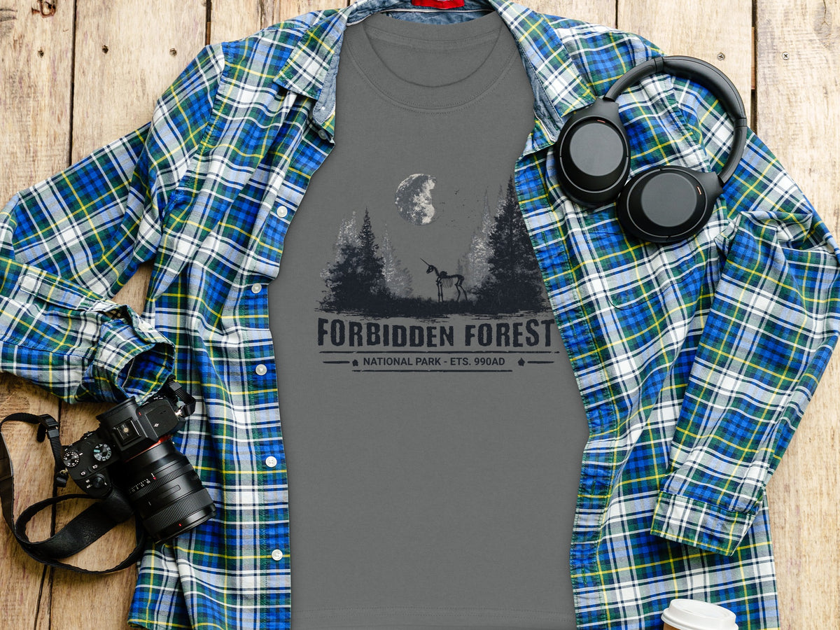 Gray t-shirt with "Forbidden Forest National Park" graphic, laid flat under a plaid shirt.