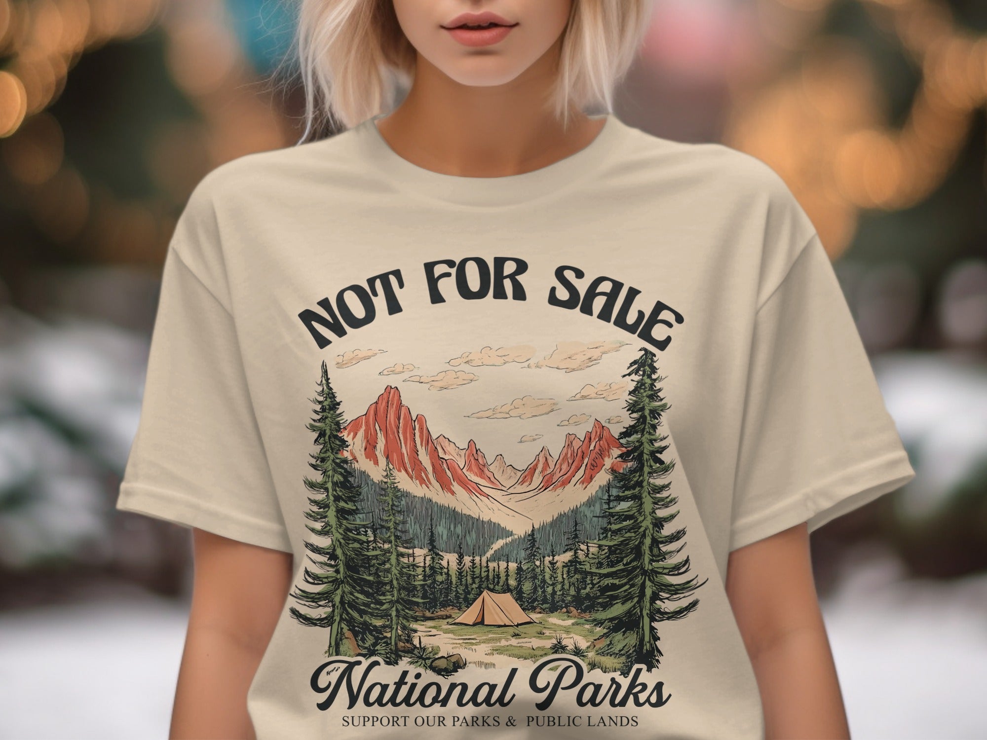 T-shirt of a mountain landscape with a tent and trees, text reads "NOT FOR SALE National Parks SUPPORT OUR PARKS & PUBLIC LANDS".