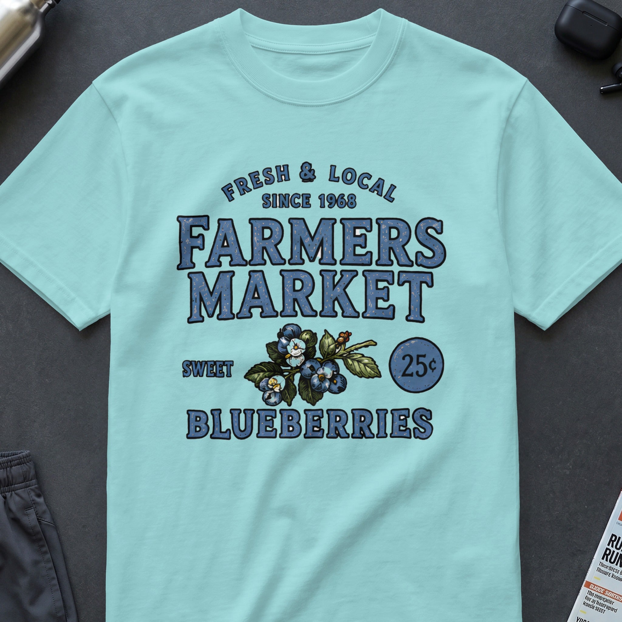 Light blue t-shirt with "Farmers Market" text, blueberries, and "Sweet Blueberries 25¢" graphic.