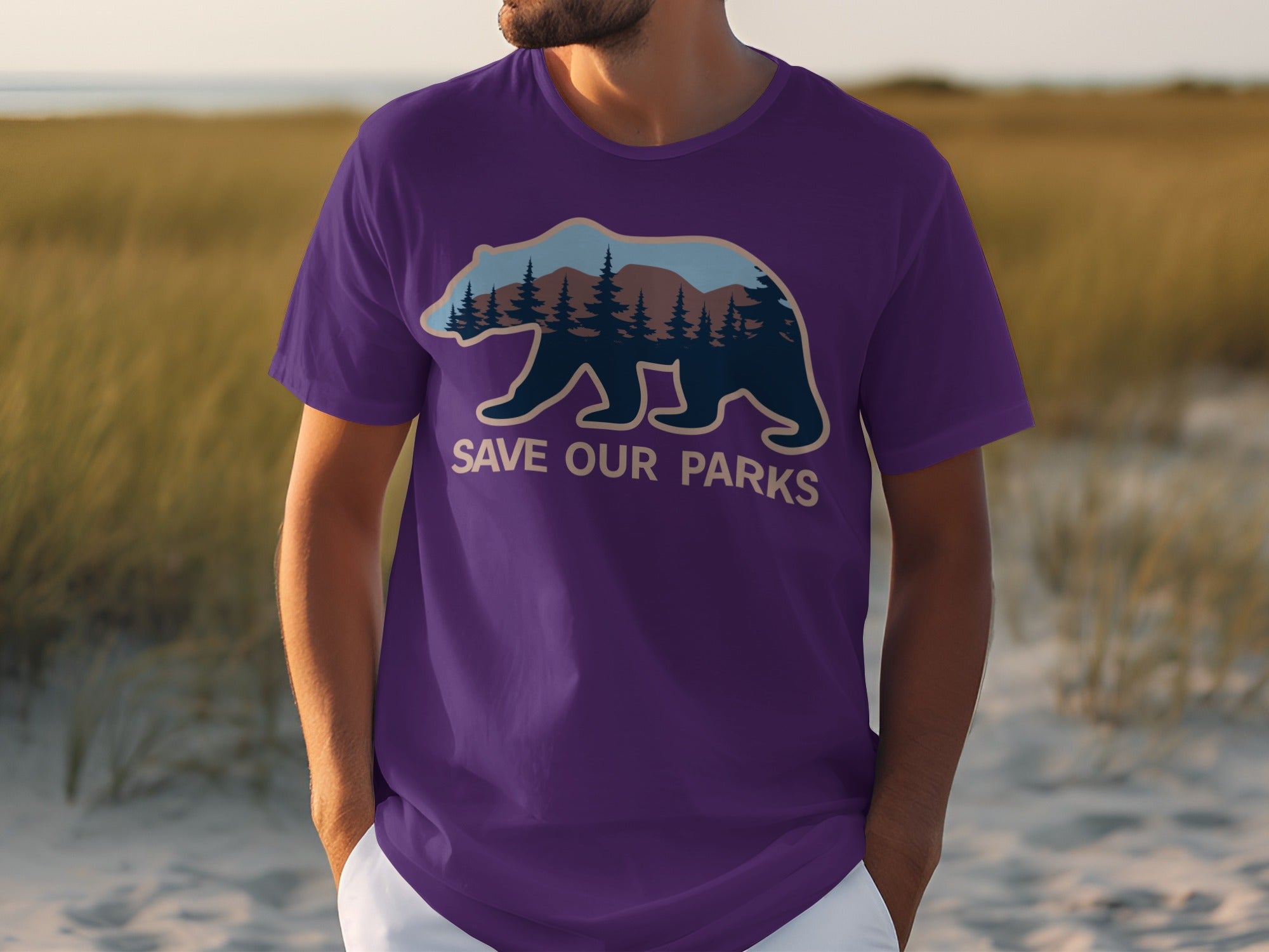 Purple t-shirt with bear silhouette containing trees and mountains. Text reads "SAVE OUR PARKS".