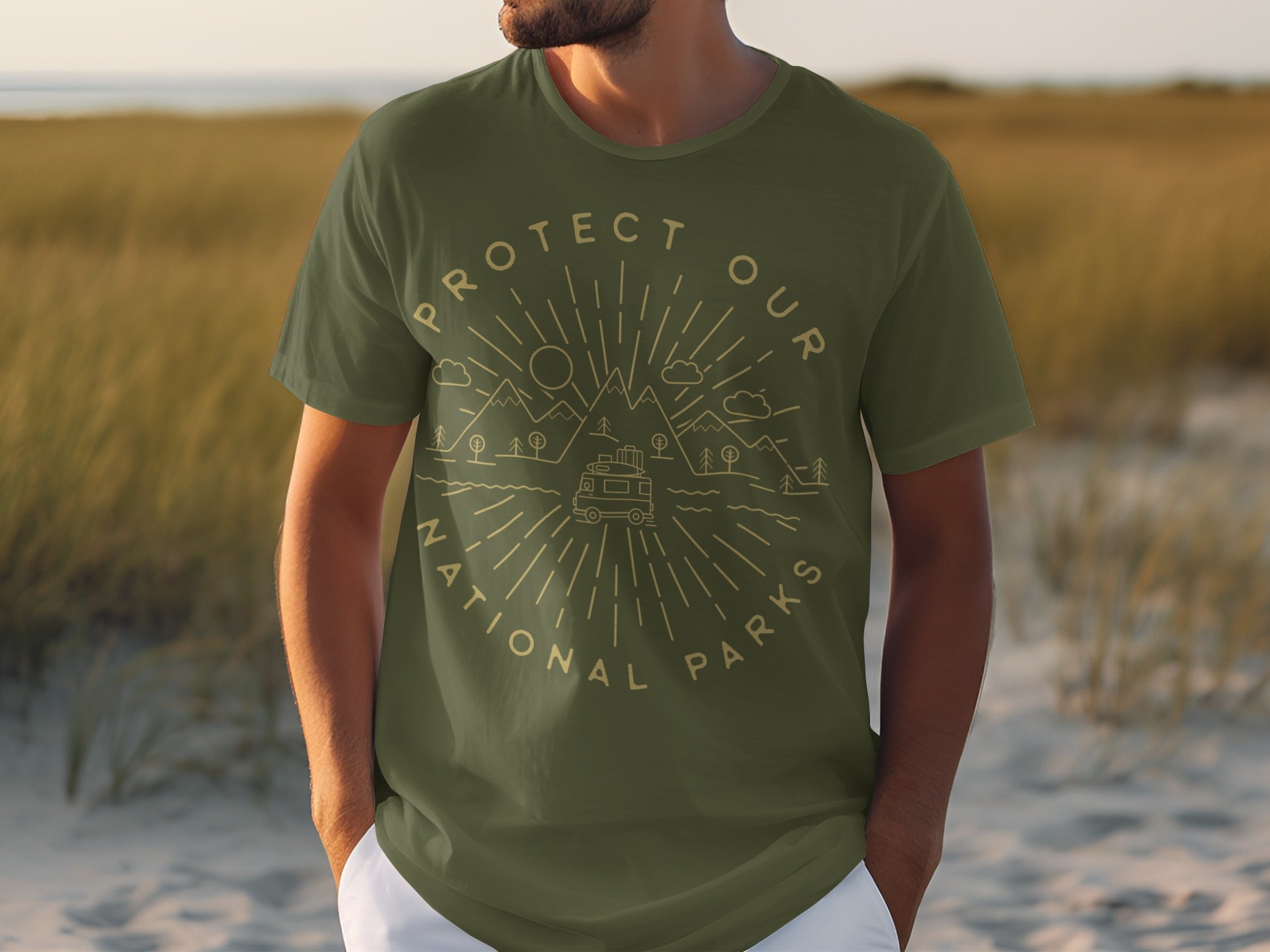 Olive green t-shirt with circular graphic of mountains, trees, clouds, and camper van.