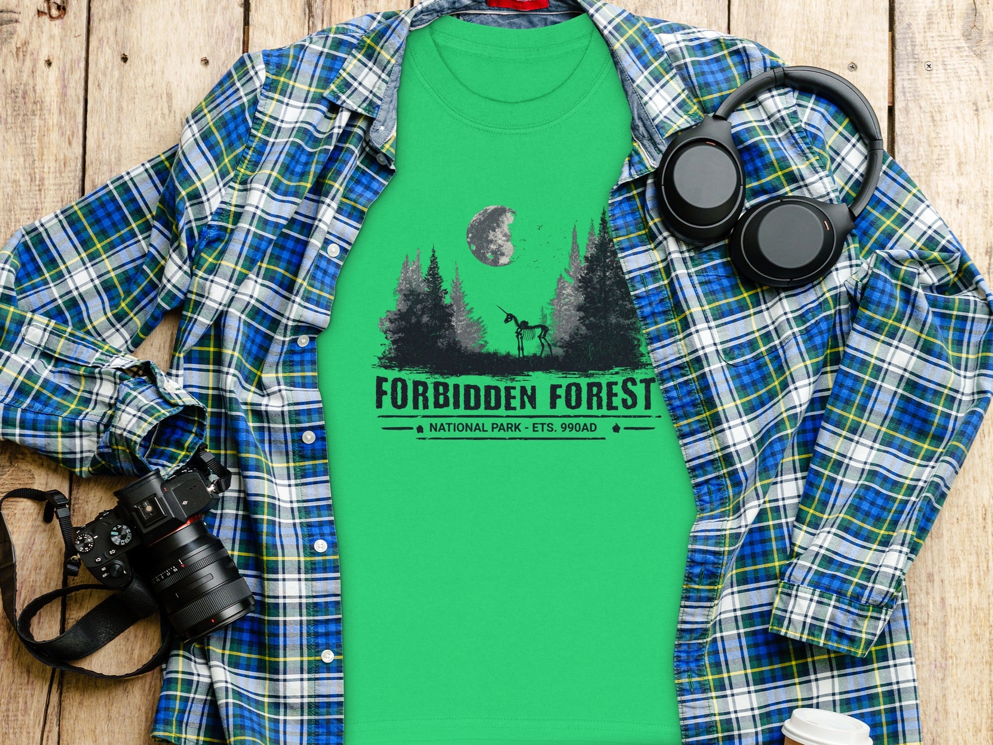 Green t-shirt with "Forbidden Forest National Park" graphic featuring a skeleton unicorn and trees.