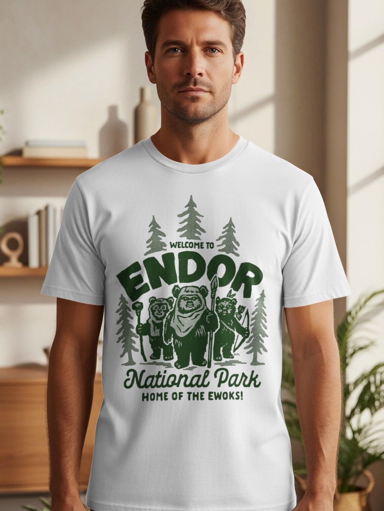 White t-shirt with graphic of Ewoks and trees, "Welcome to Endor National Park Home of the Ewoks!"