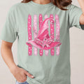 Pink witch hat with breast cancer ribbons on striped background.