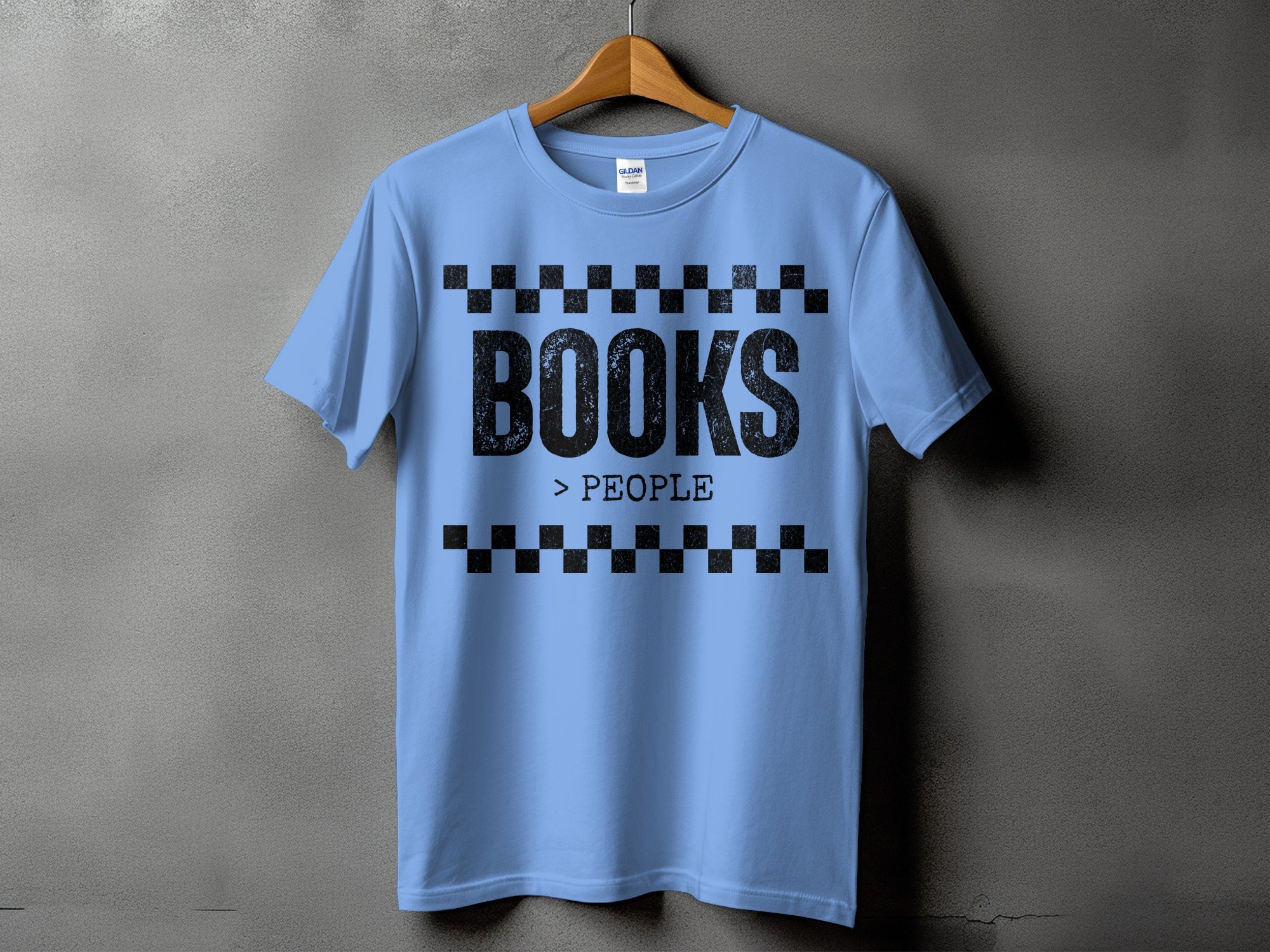 Light blue t-shirt with black text that reads "BOOKS > PEOPLE" with checkered borders.