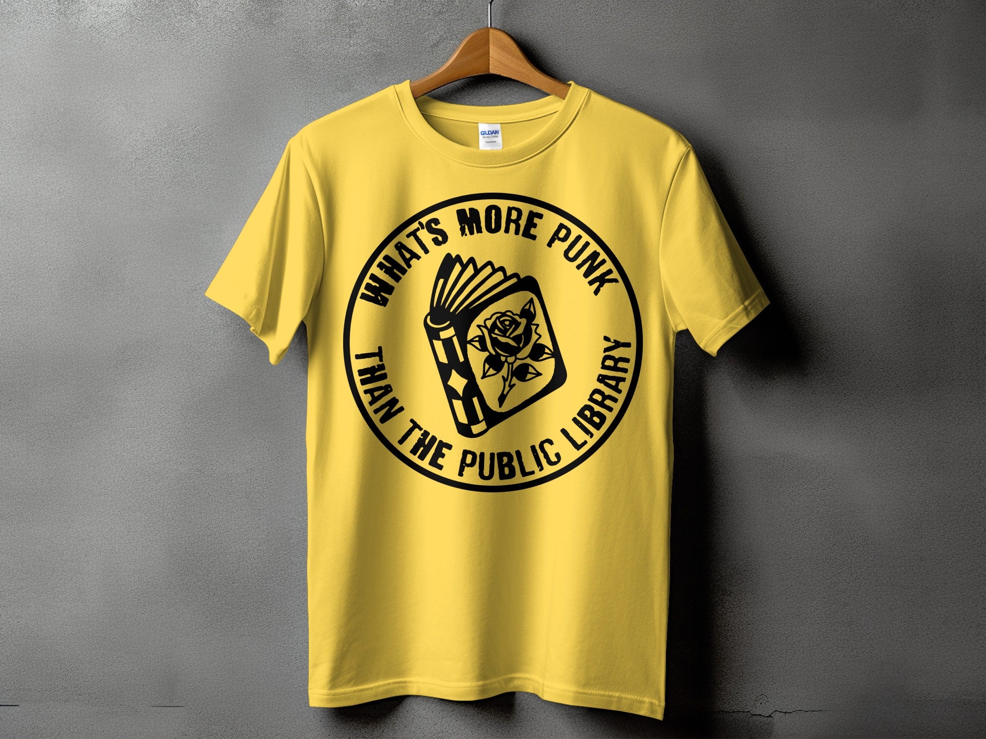 Yellow t-shirt with "What's More Punk Than The Public Library" text and a book with a rose.