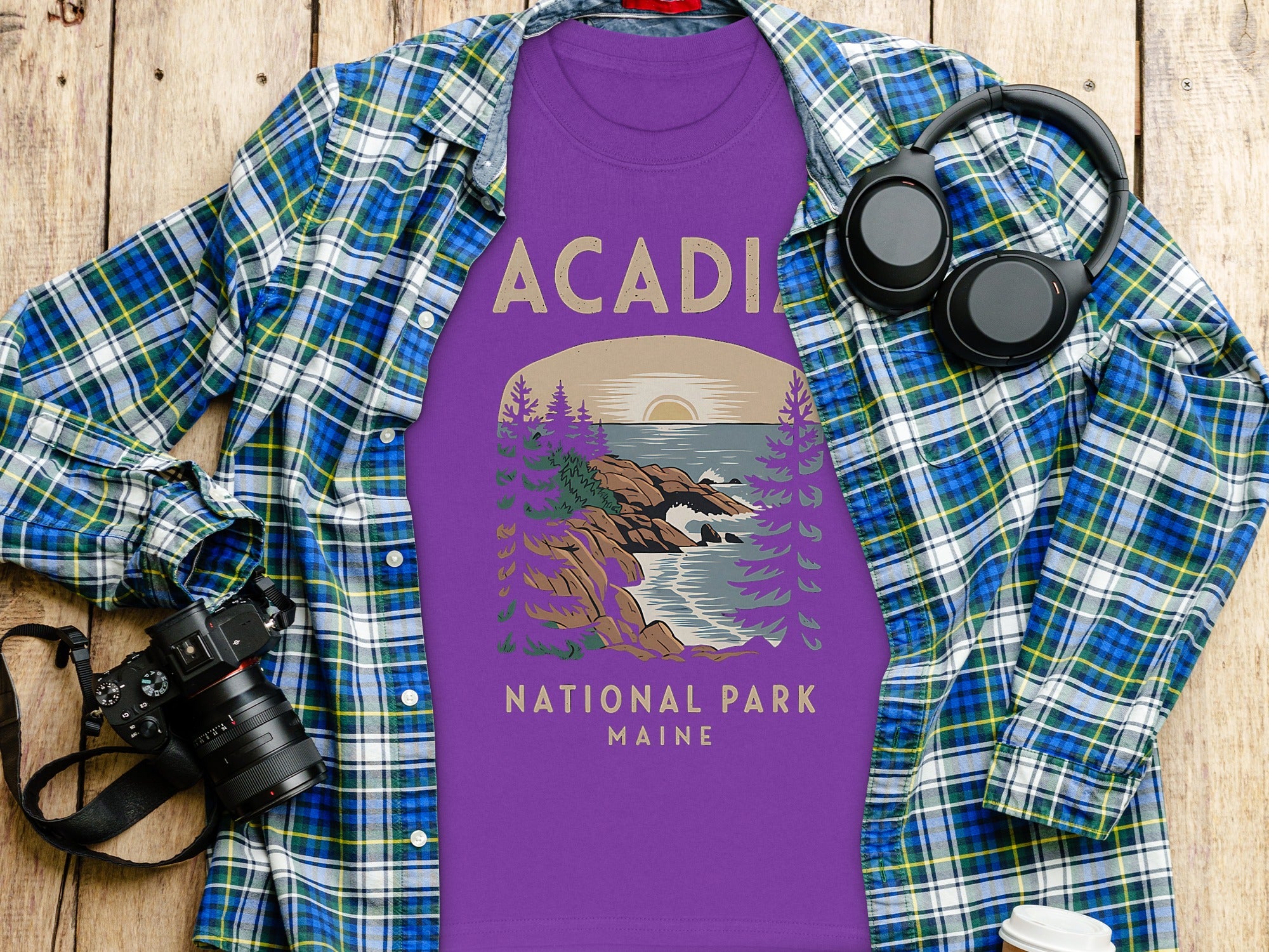 Purple t-shirt with "Acadia National Park Maine" graphic, over a plaid shirt.