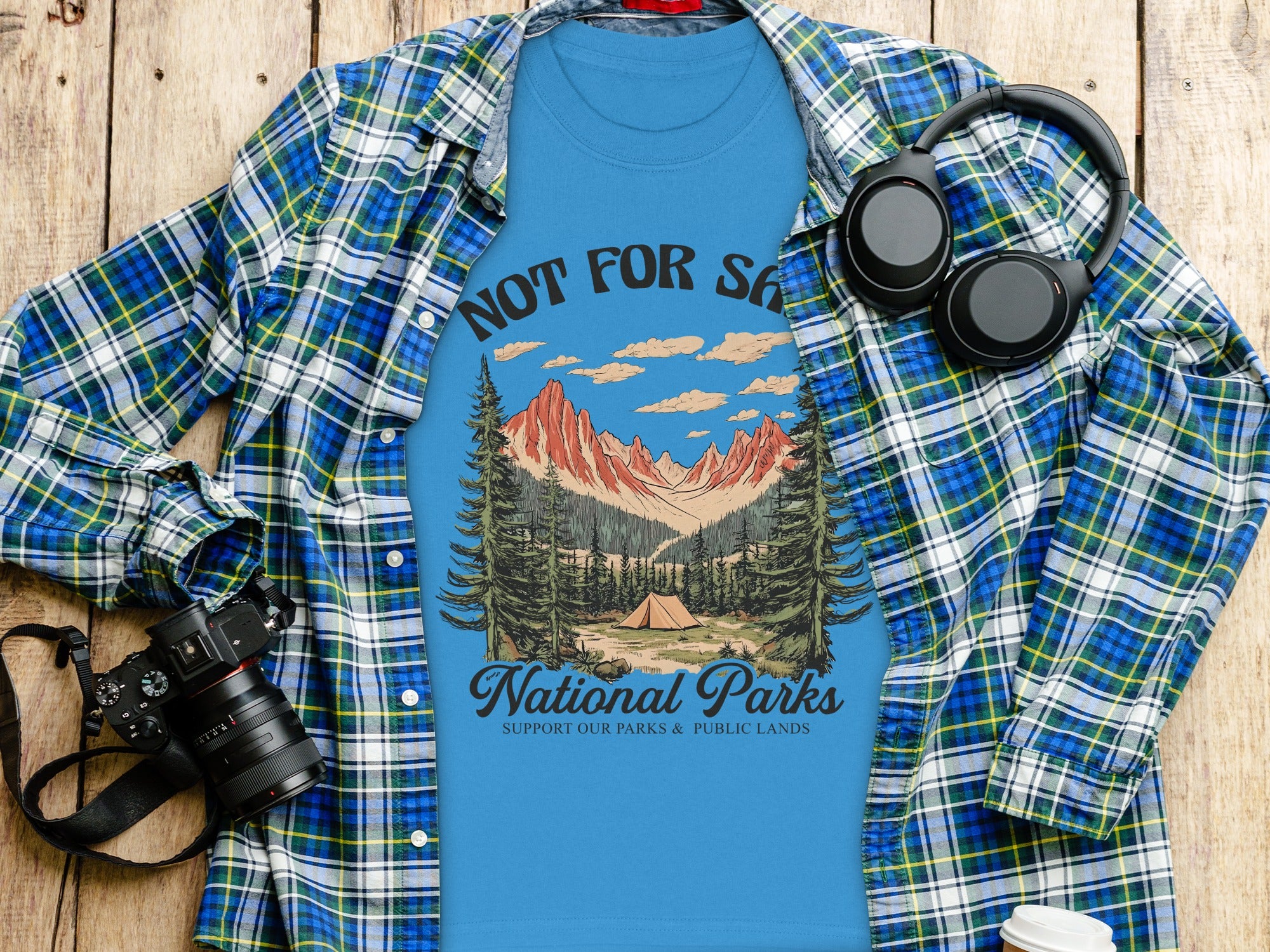 Blue t-shirt with "National Parks" graphic of mountains, trees, and tent.