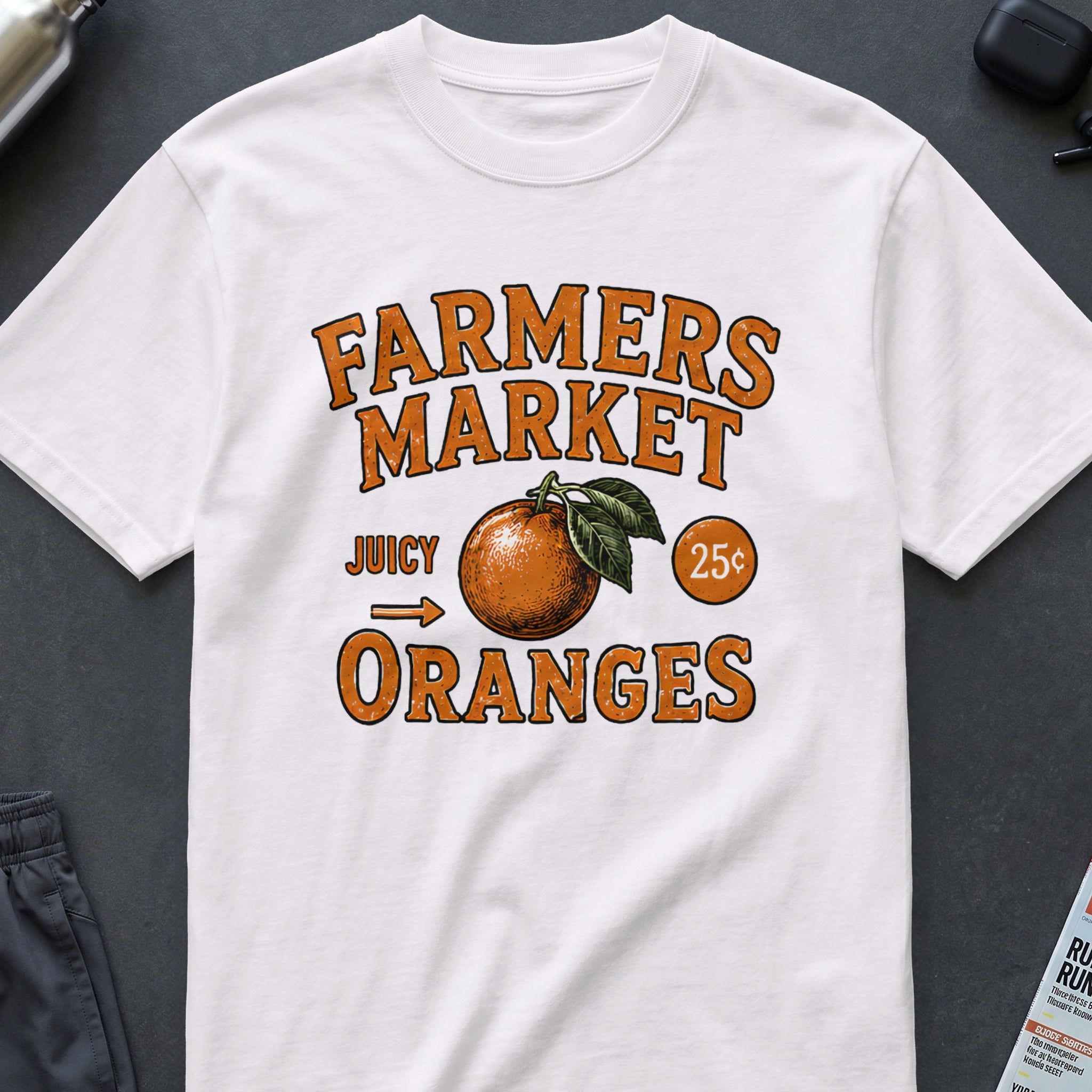 White t-shirt with "Farmers Market Juicy Oranges 25¢" graphic.
