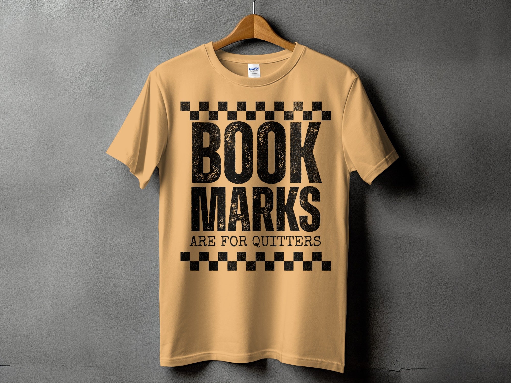 Light tan t-shirt with black text "BOOK MARKS ARE FOR QUITTERS".