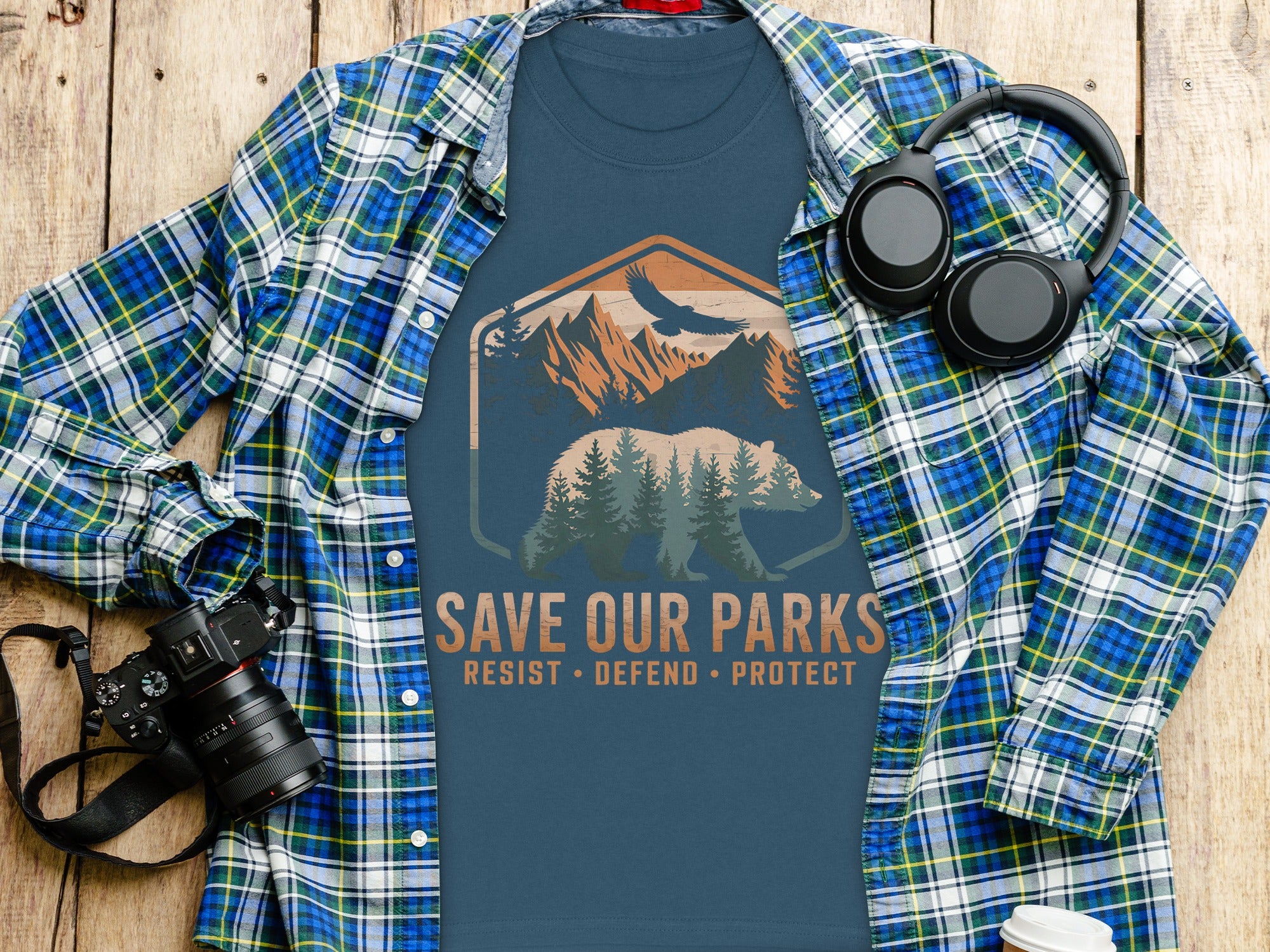 Blue t-shirt with "Save Our Parks" design and a plaid shirt.