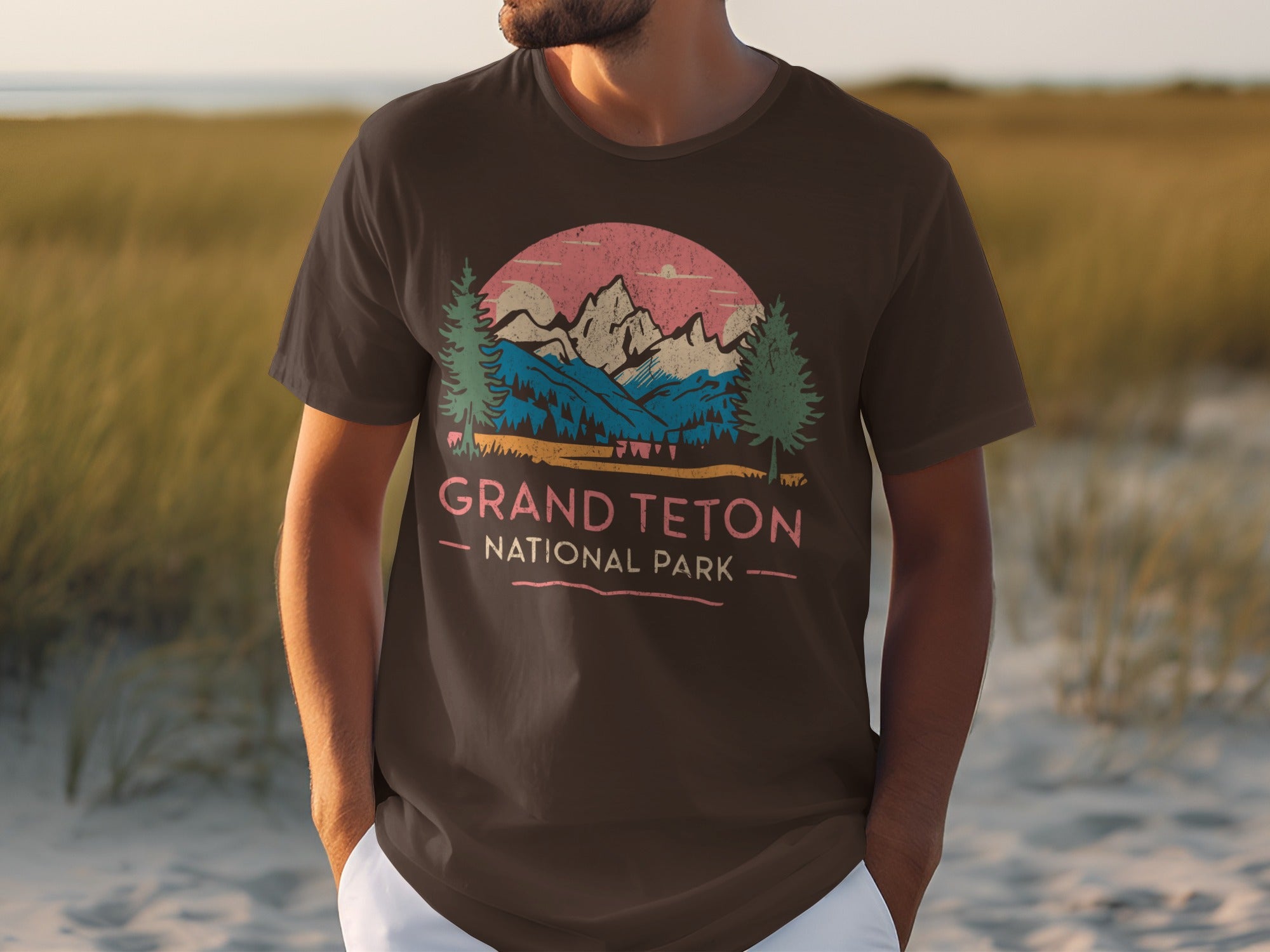 Brown t-shirt with Grand Teton National Park mountain landscape graphic and text.