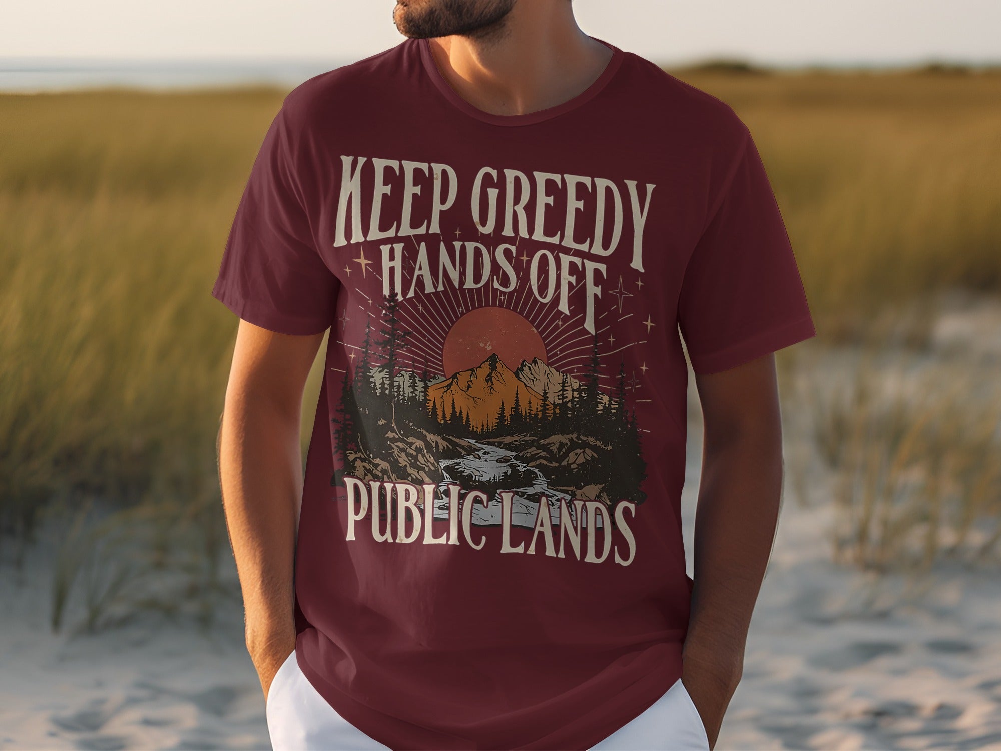 Maroon t-shirt with "KEEP GREEDY HANDS OFF PUBLIC LANDS" and nature graphic.