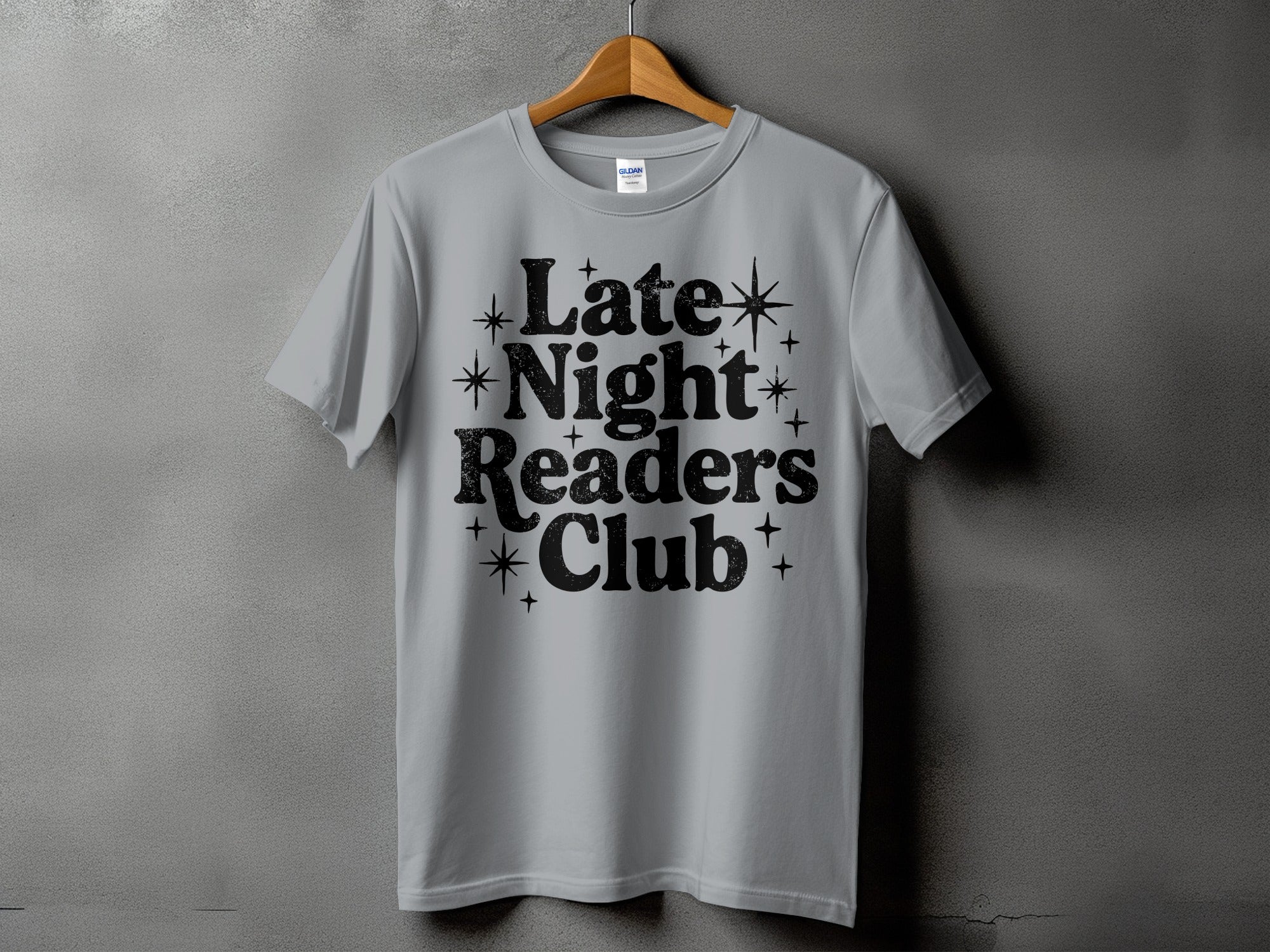 Light grey t-shirt with black text "Late Night Readers Club" and star accents.