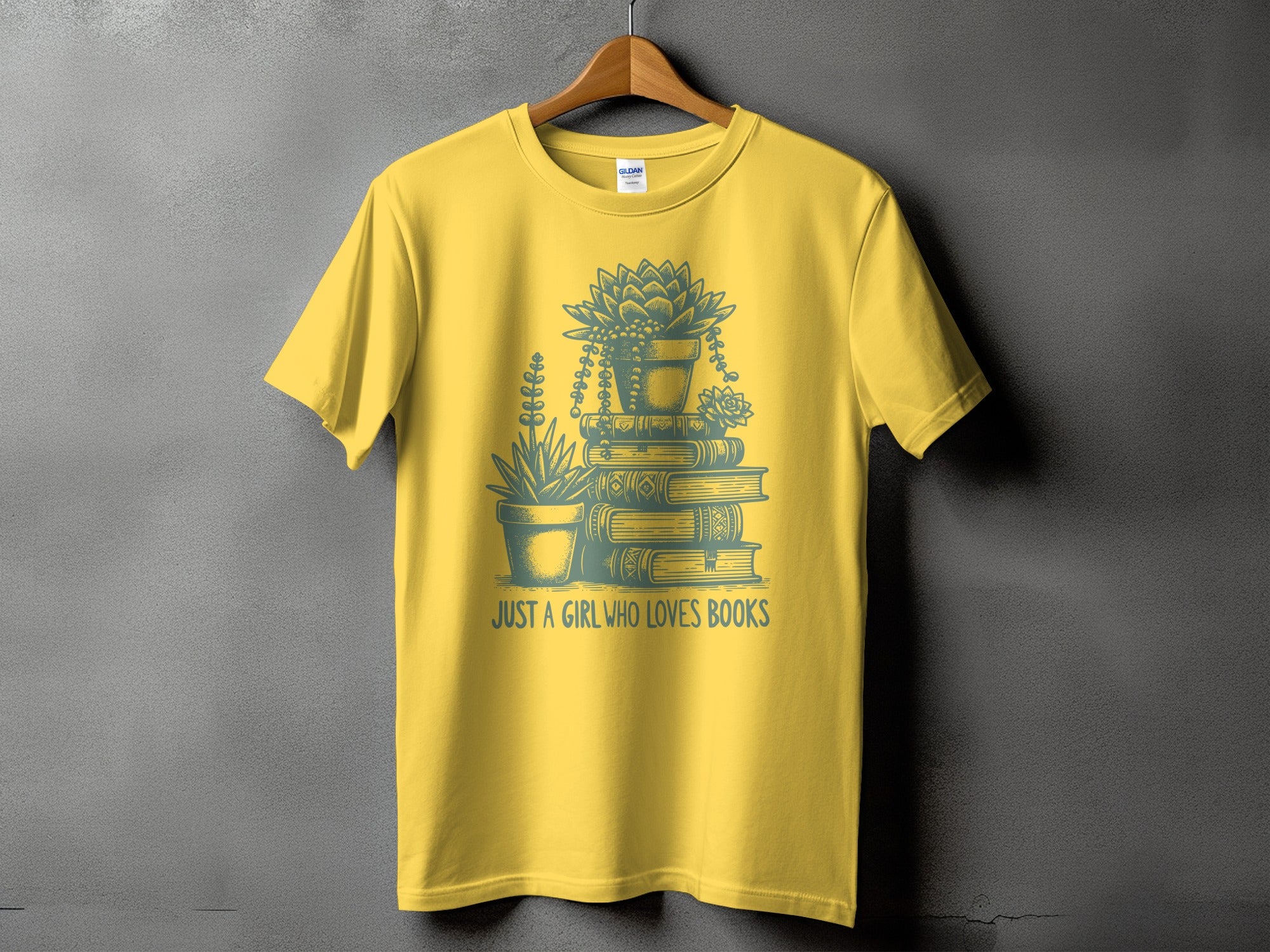 Yellow t-shirt with a graphic of potted succulents on books and text "JUST A GIRL WHO LOVES BOOKS".