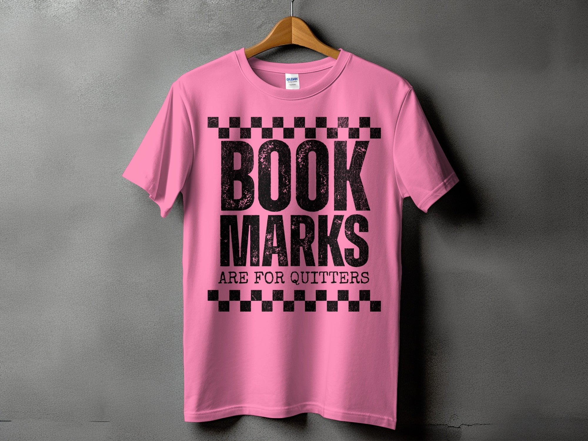 Pink t-shirt with black distressed text reading "BOOK MARKS ARE FOR QUITTERS."
