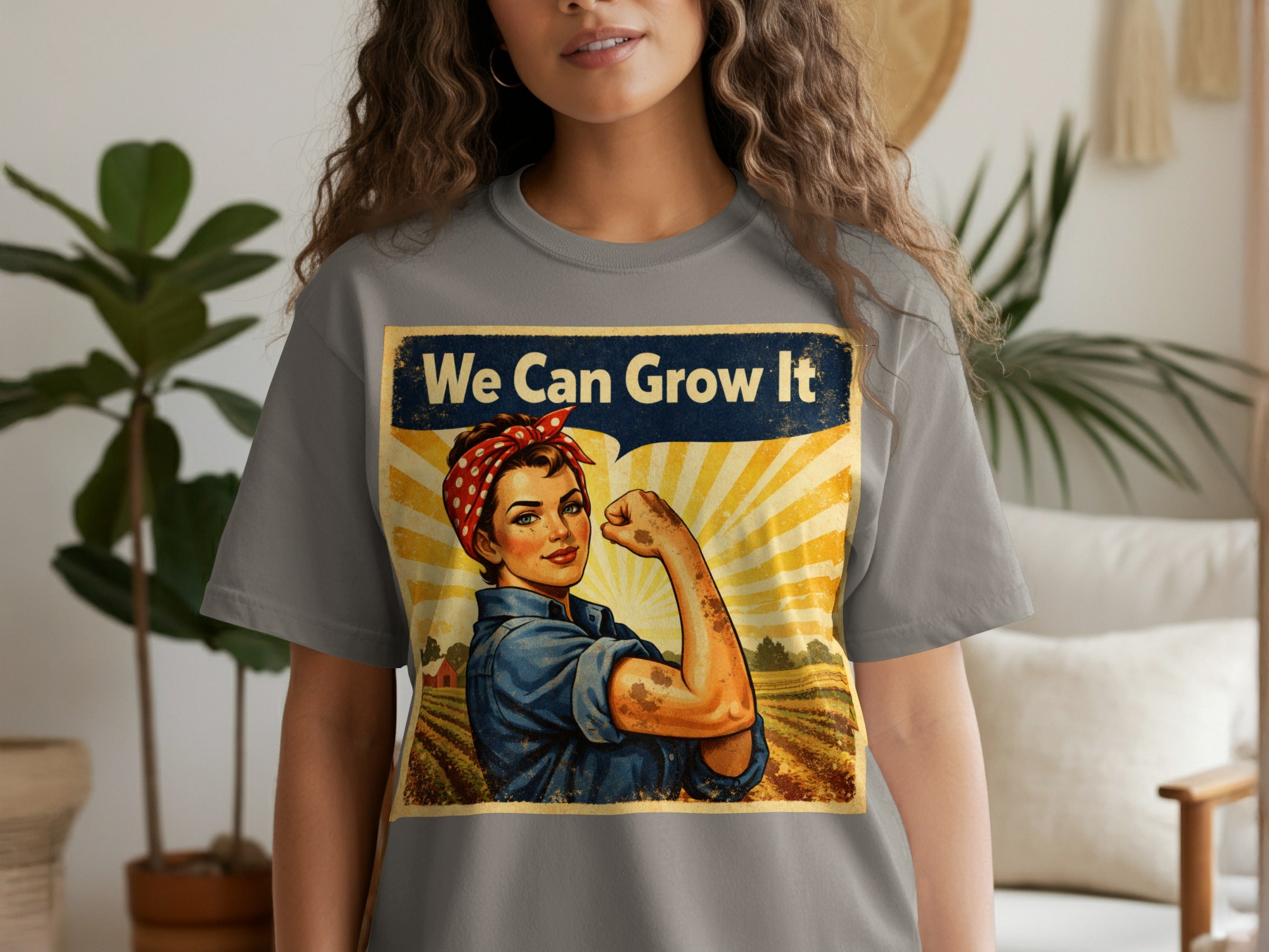 Rosie the Riveter illustration with text "We Can Grow It" on a grey t-shirt.