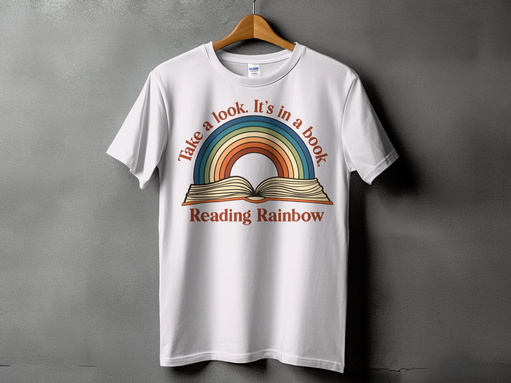 White t-shirt with "Take a look. It's in a book." and "Reading Rainbow" text.