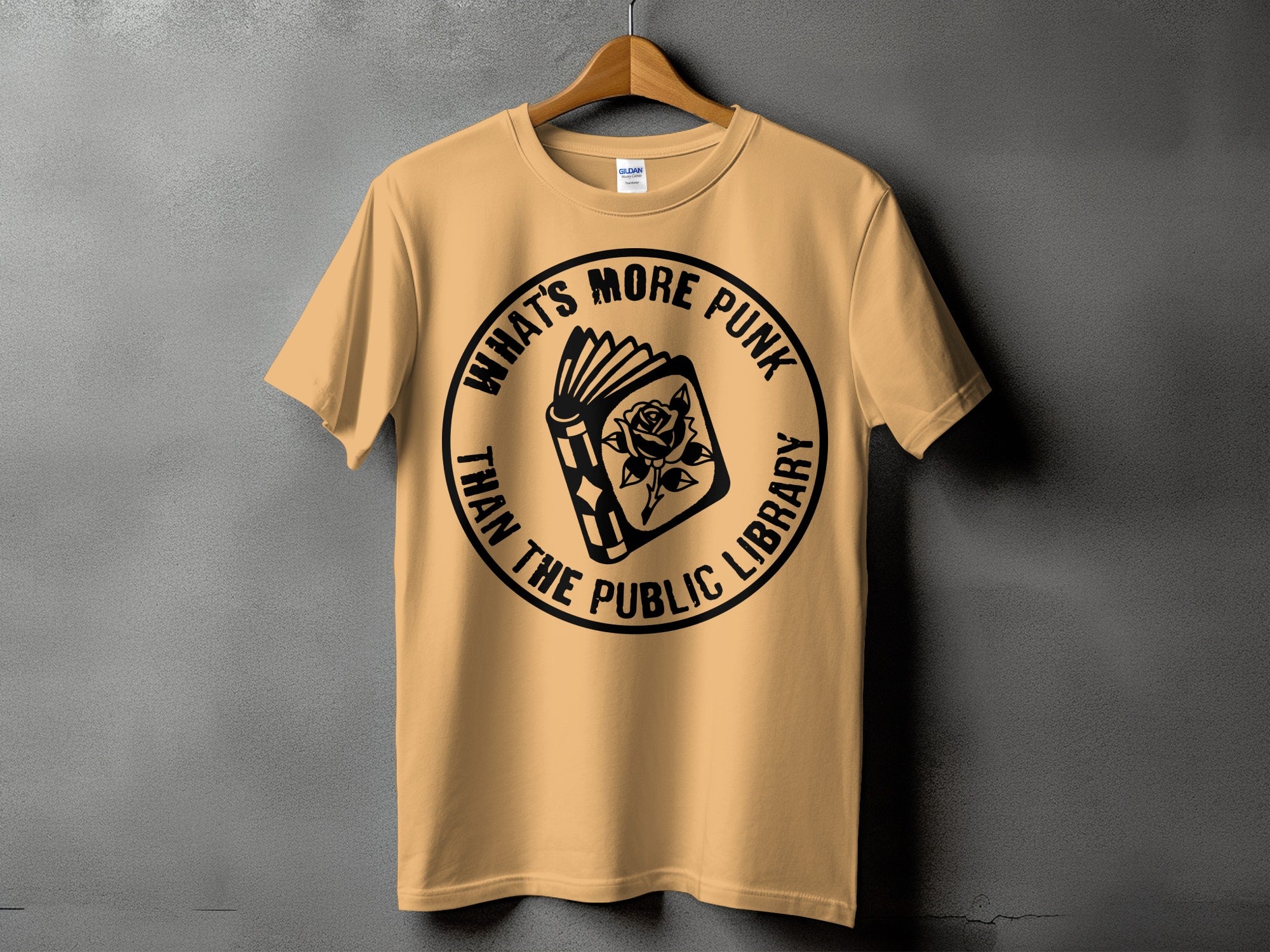Peach t-shirt with black text and graphic of an open book with a rose.