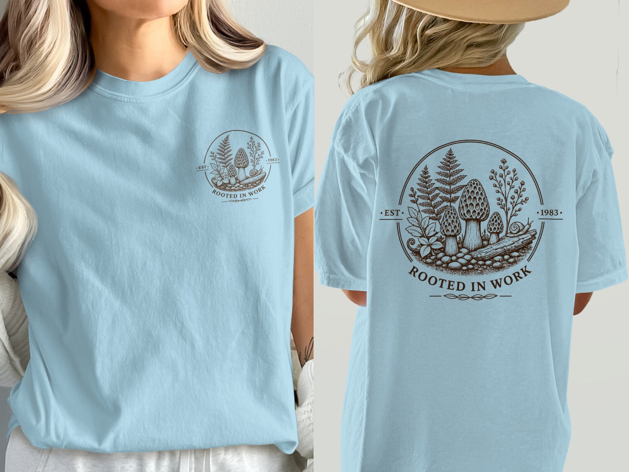 Light blue t-shirt with a brown circular graphic of mushrooms and ferns with text.