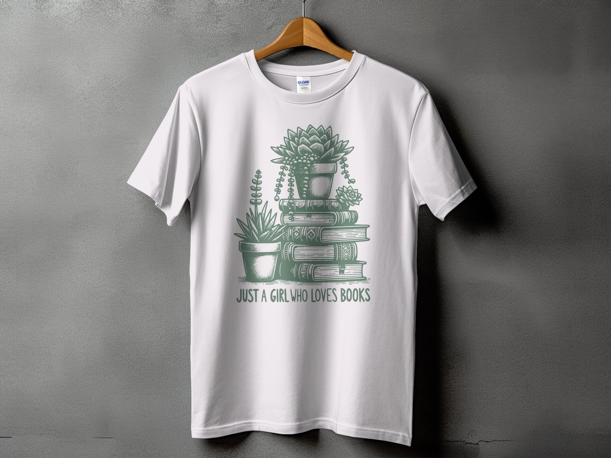 White t-shirt with stacked books, potted succulents, and text "JUST A GIRL WHO LOVES BOOKS".