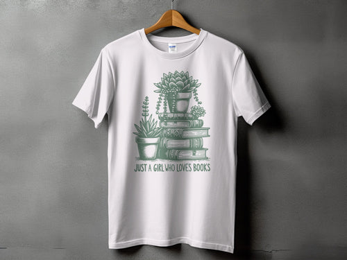 White t-shirt with stacked books, potted succulents, and text "JUST A GIRL WHO LOVES BOOKS".